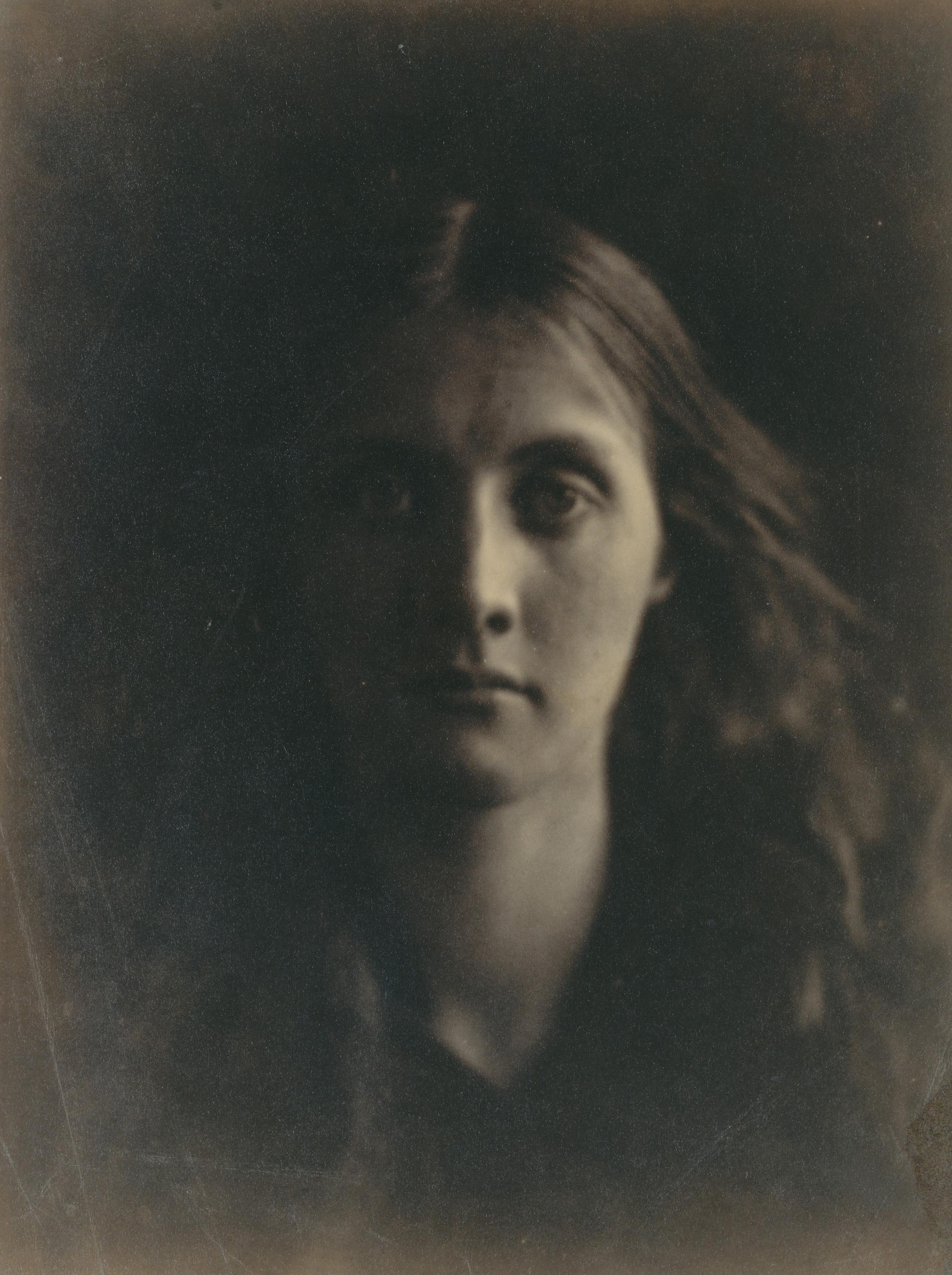 Blurry black and white photograph of a young woman with long hair.