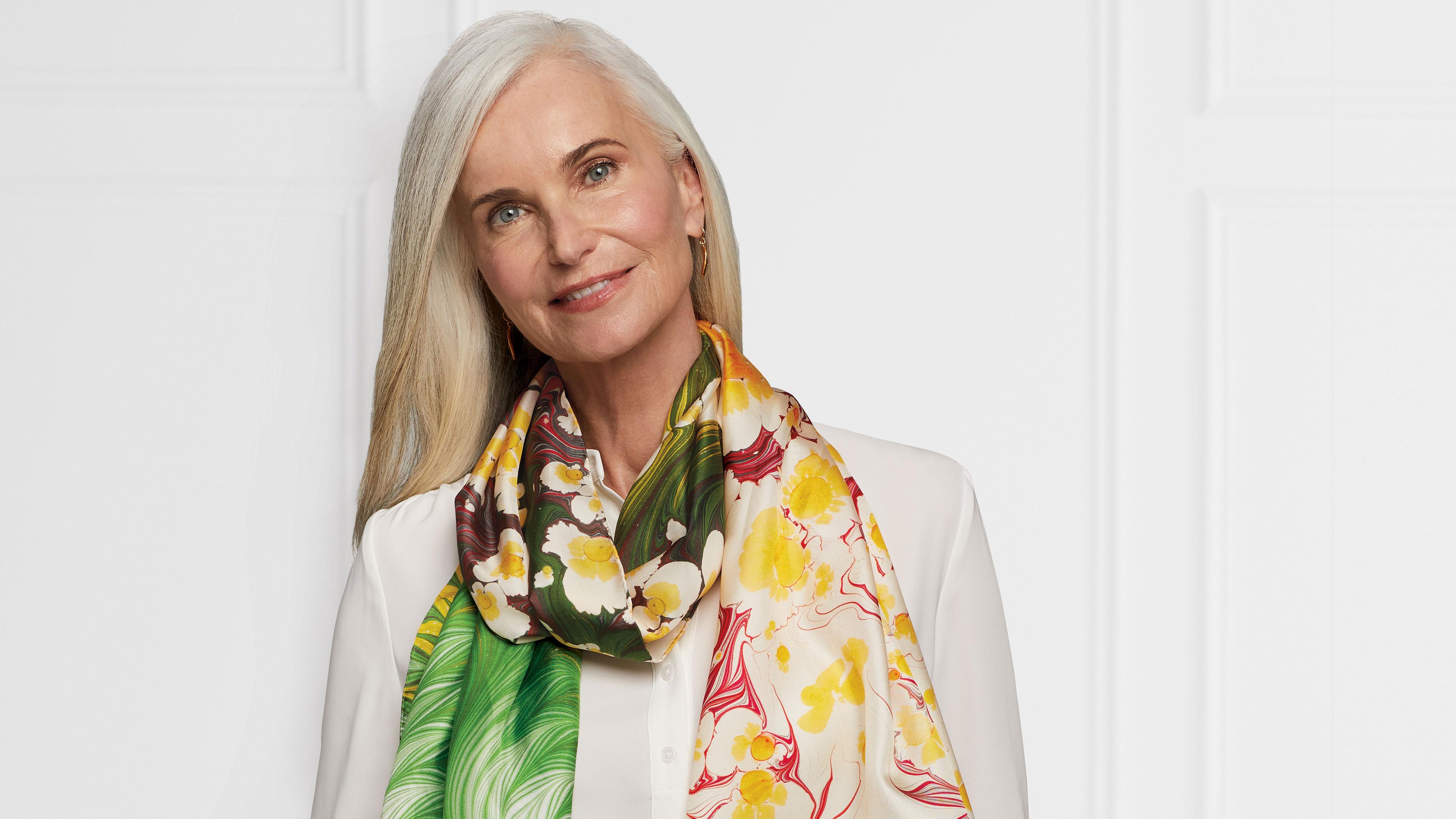 Person wearing a colorful floral scarf from The Met Store
