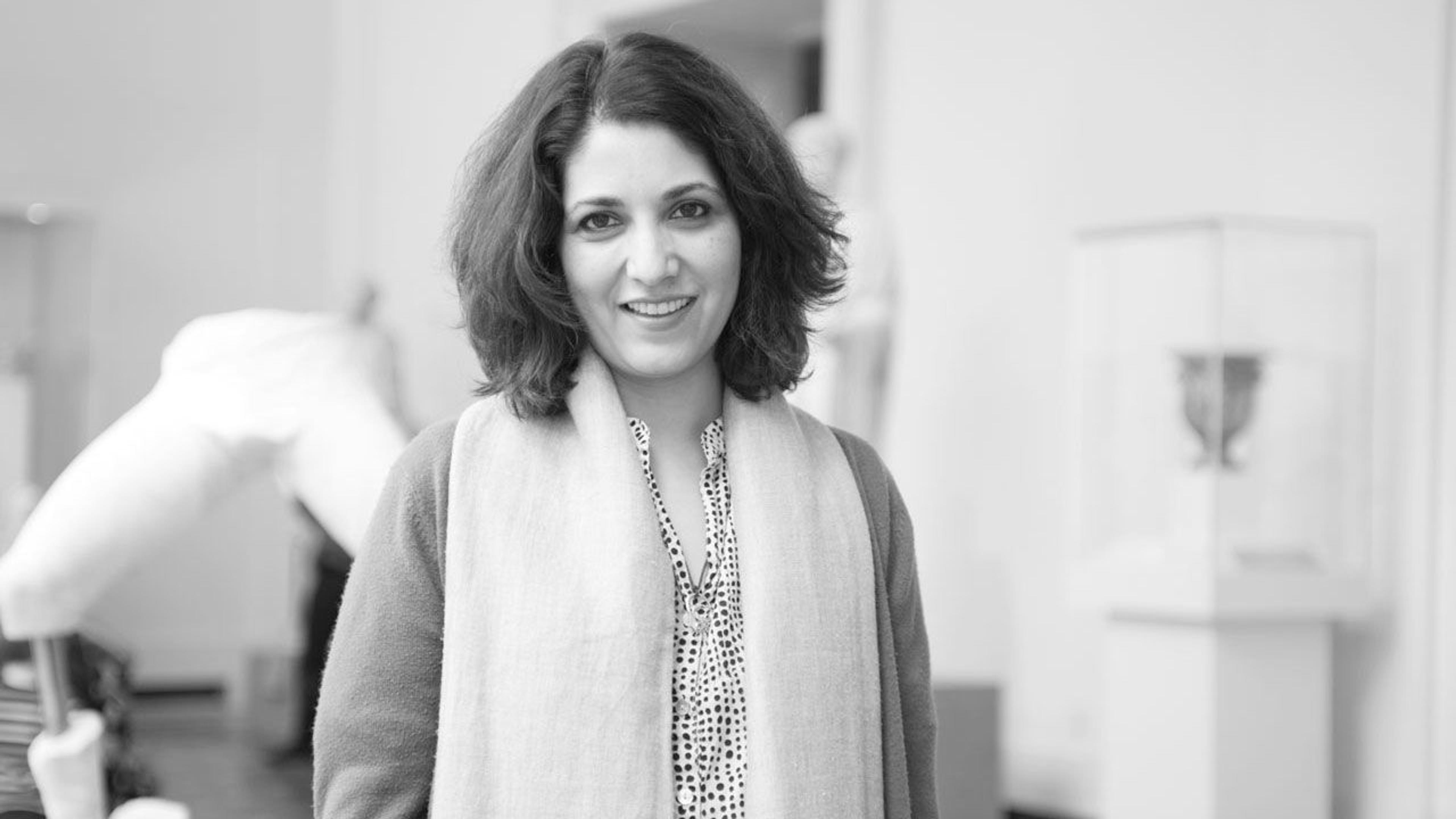 Black and white photograph of curator Navina Haidar in The Met galleries