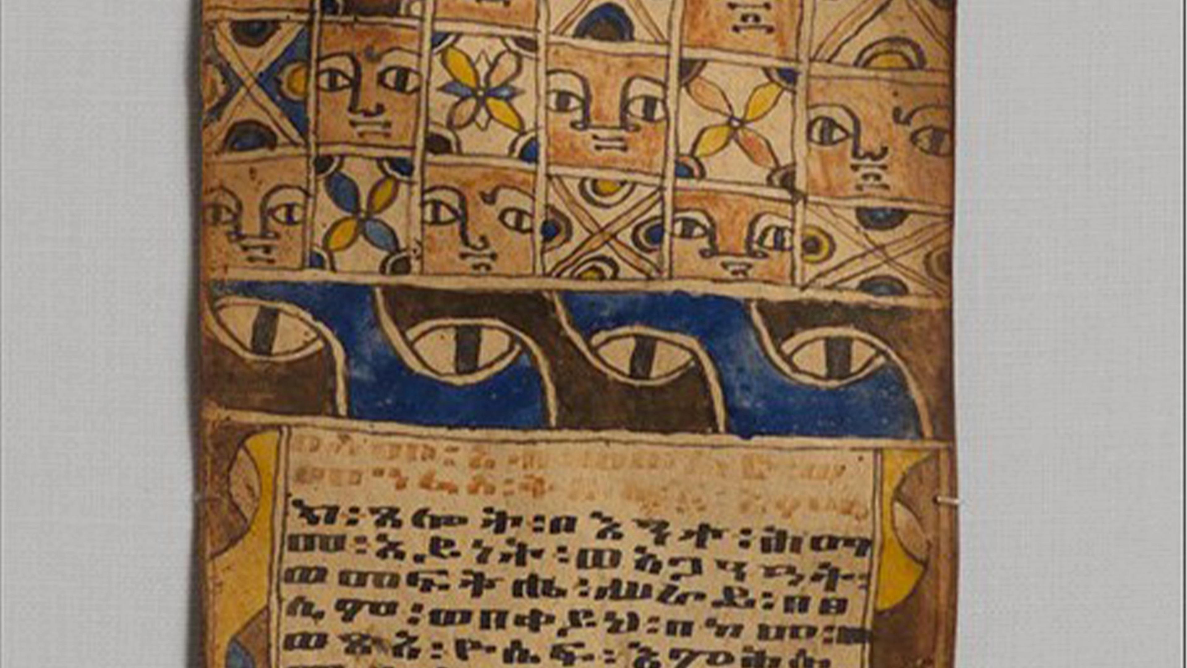 Close up of a healing scroll showing alternating patterns of human faces, abstract designs, eyes, and text
