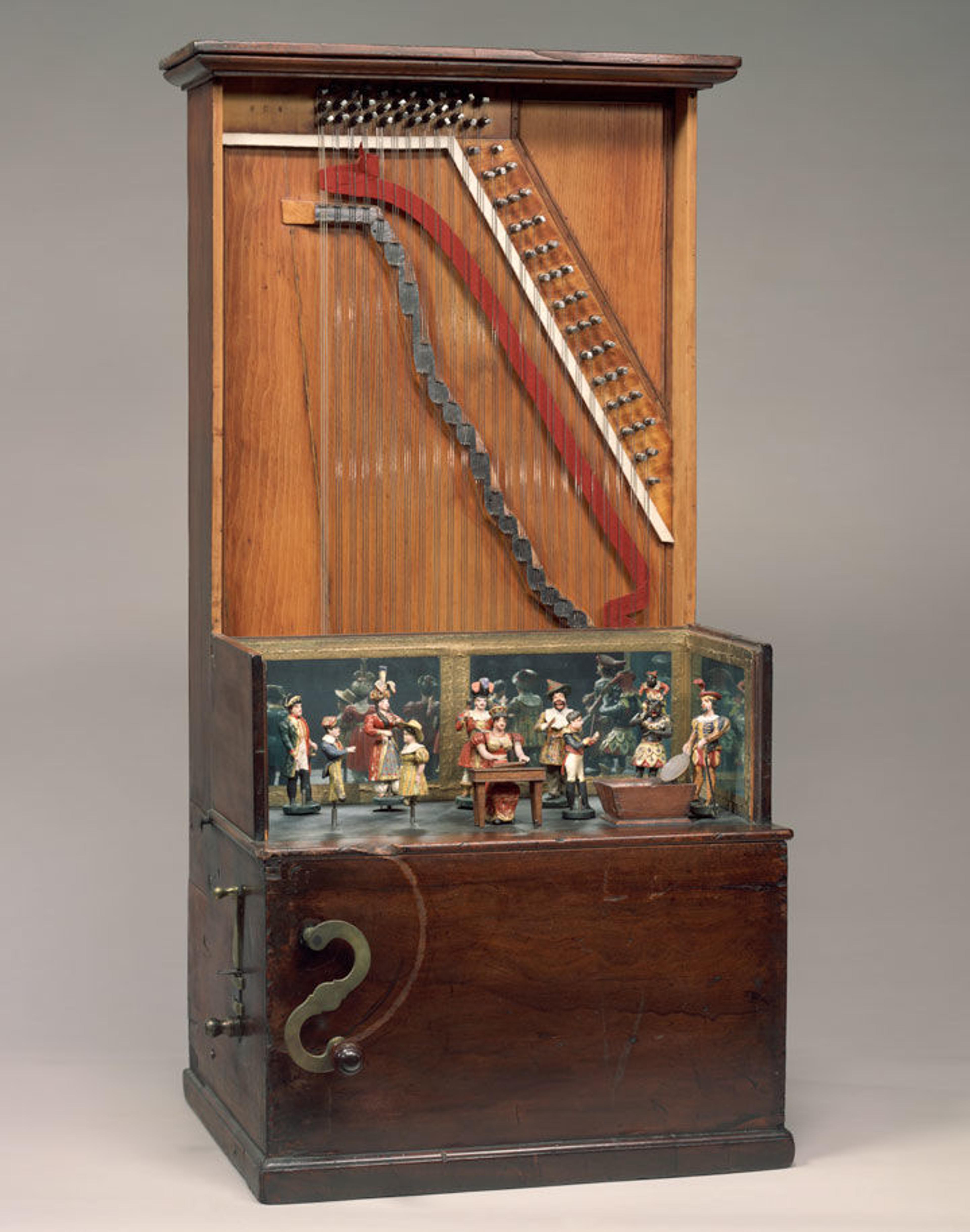 Barrel piano showing exposed piano strings and a series of costumed puppets