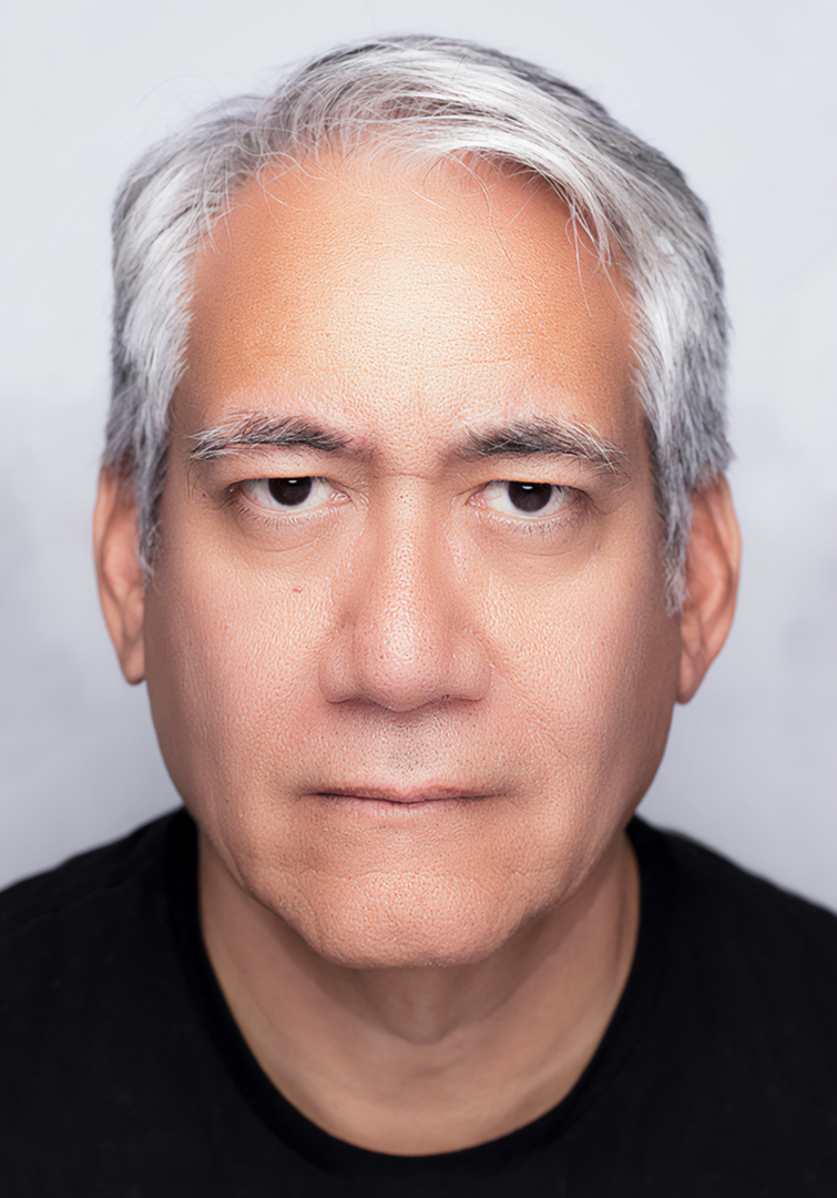Portrait of a person with short gray hair and a black shirt against a white background