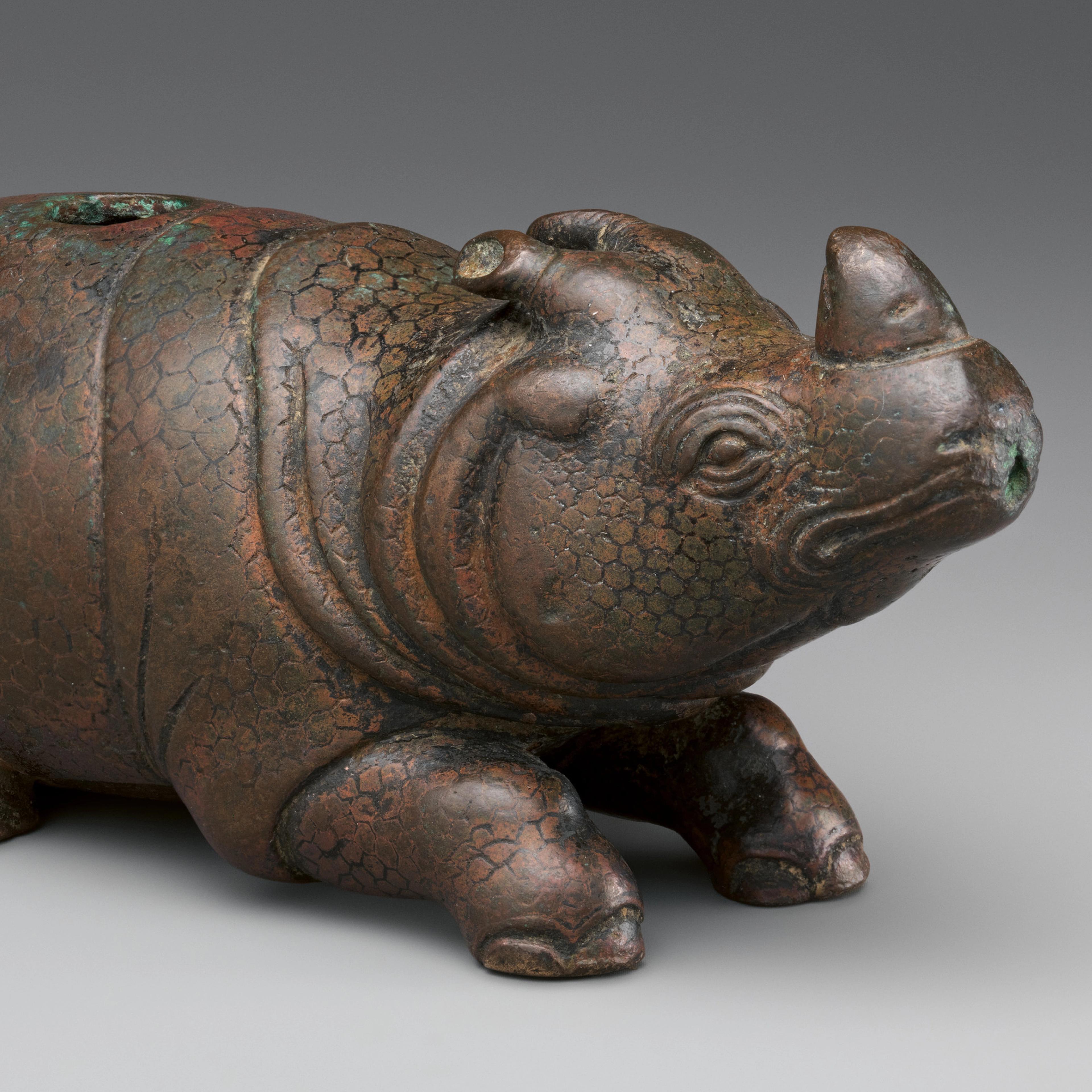 Water dropper in the shape of a rhinoceros.