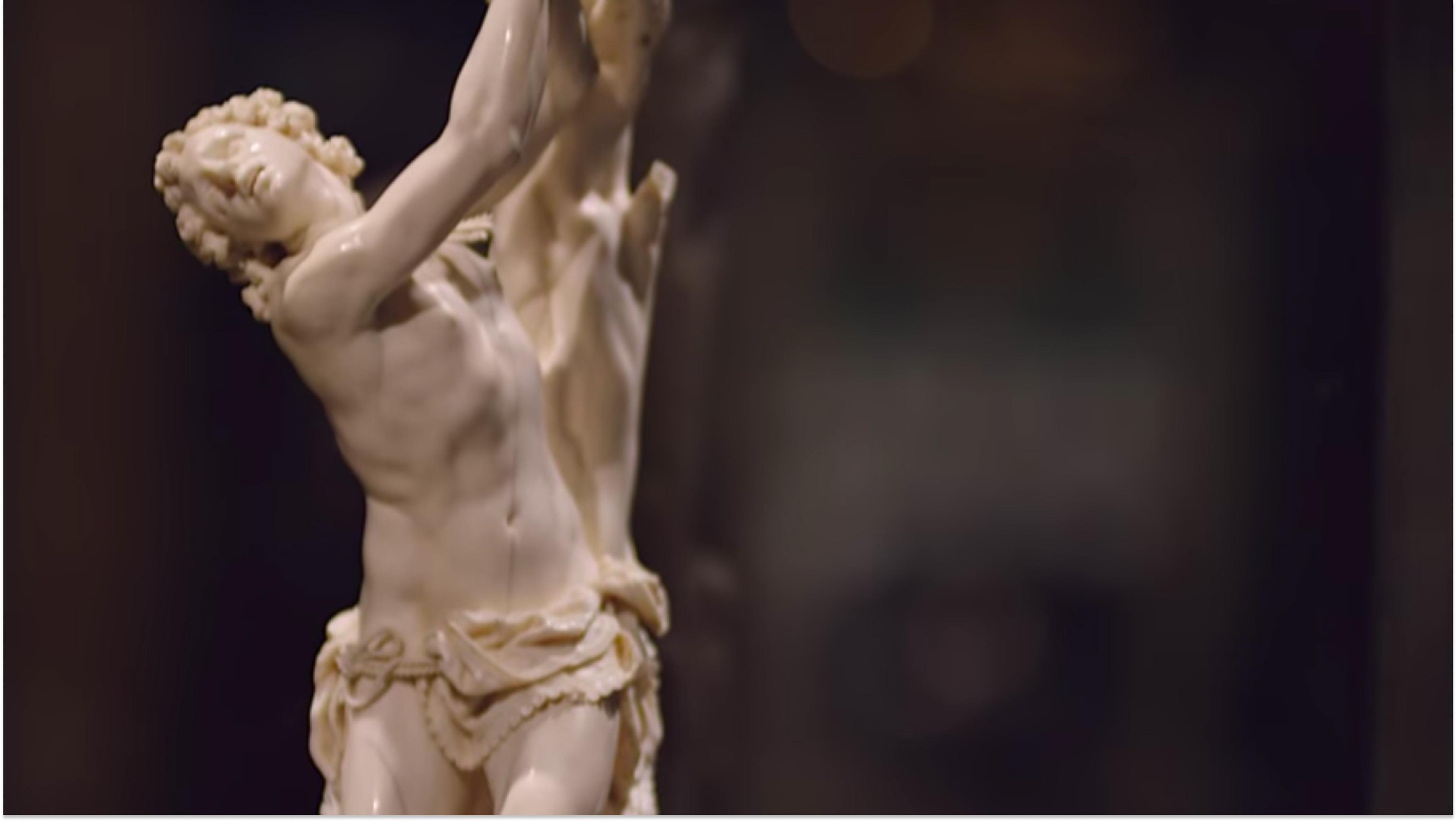 Marble sculpture of a man with a twisted torso.