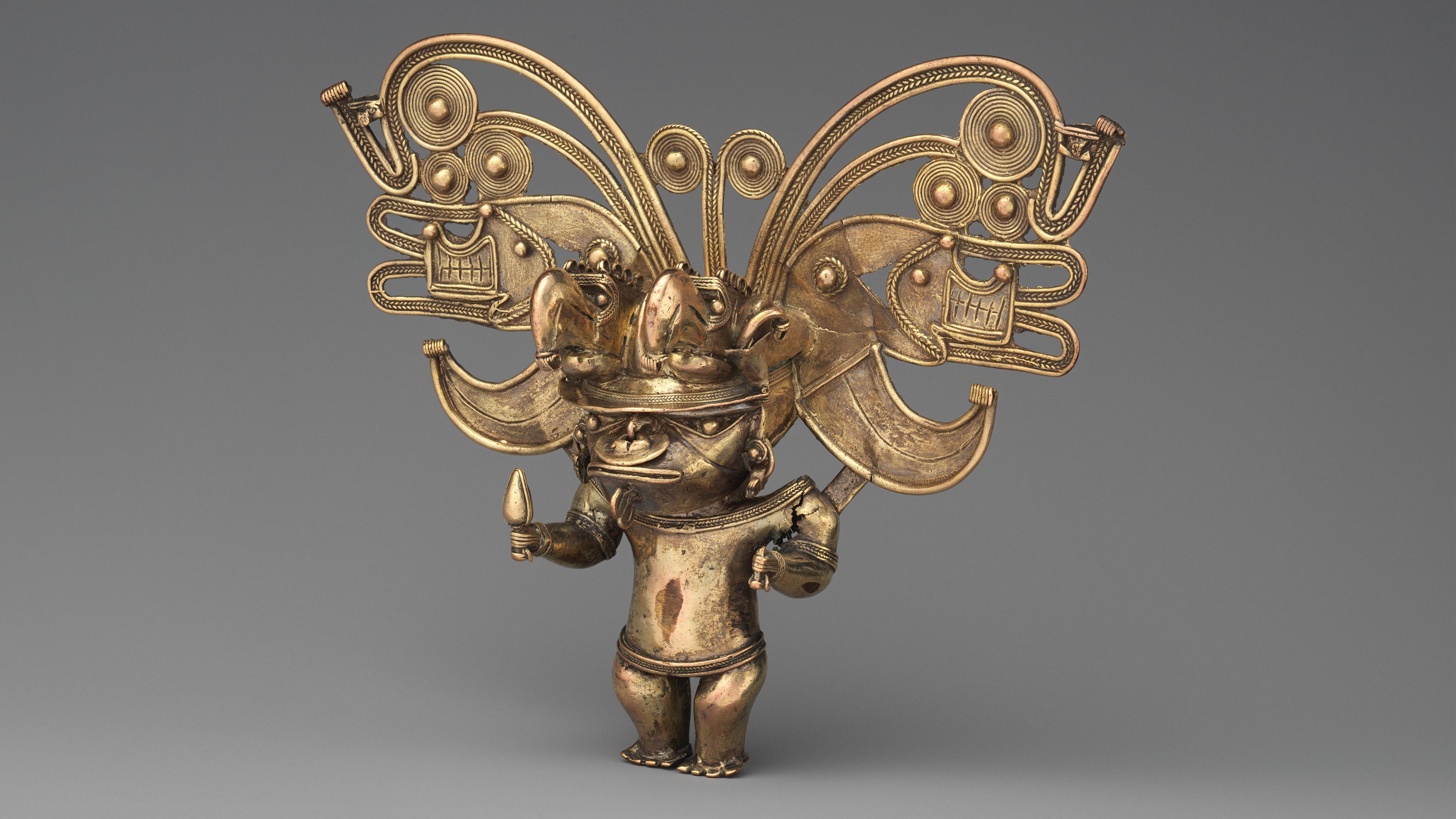Gold pendant of a human figure wearing an elaborate headdress