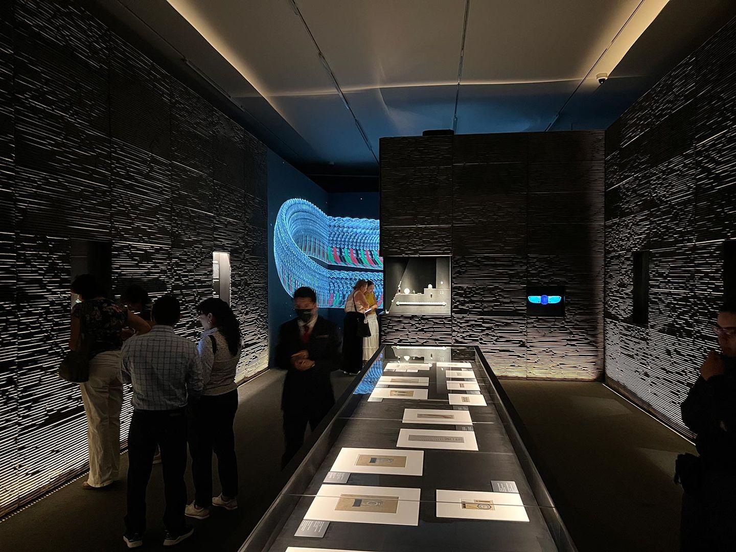 Installation view that is a mix of darkness and neon color