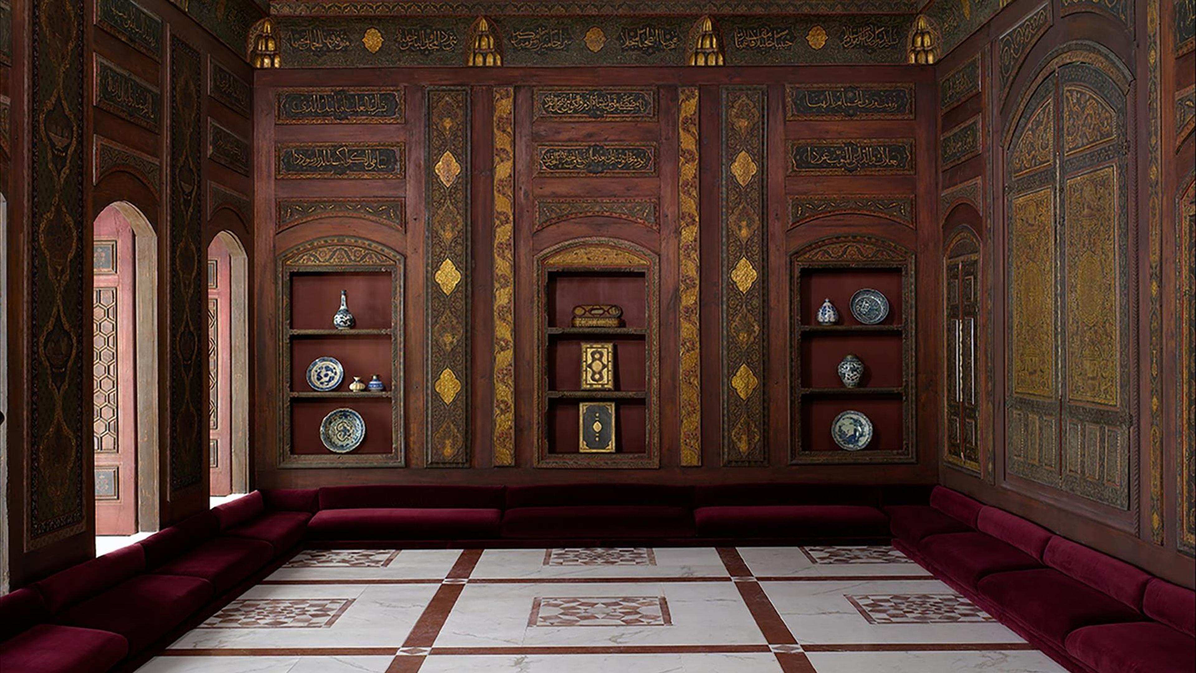 A carved interior with tiled floors and dark wood walls