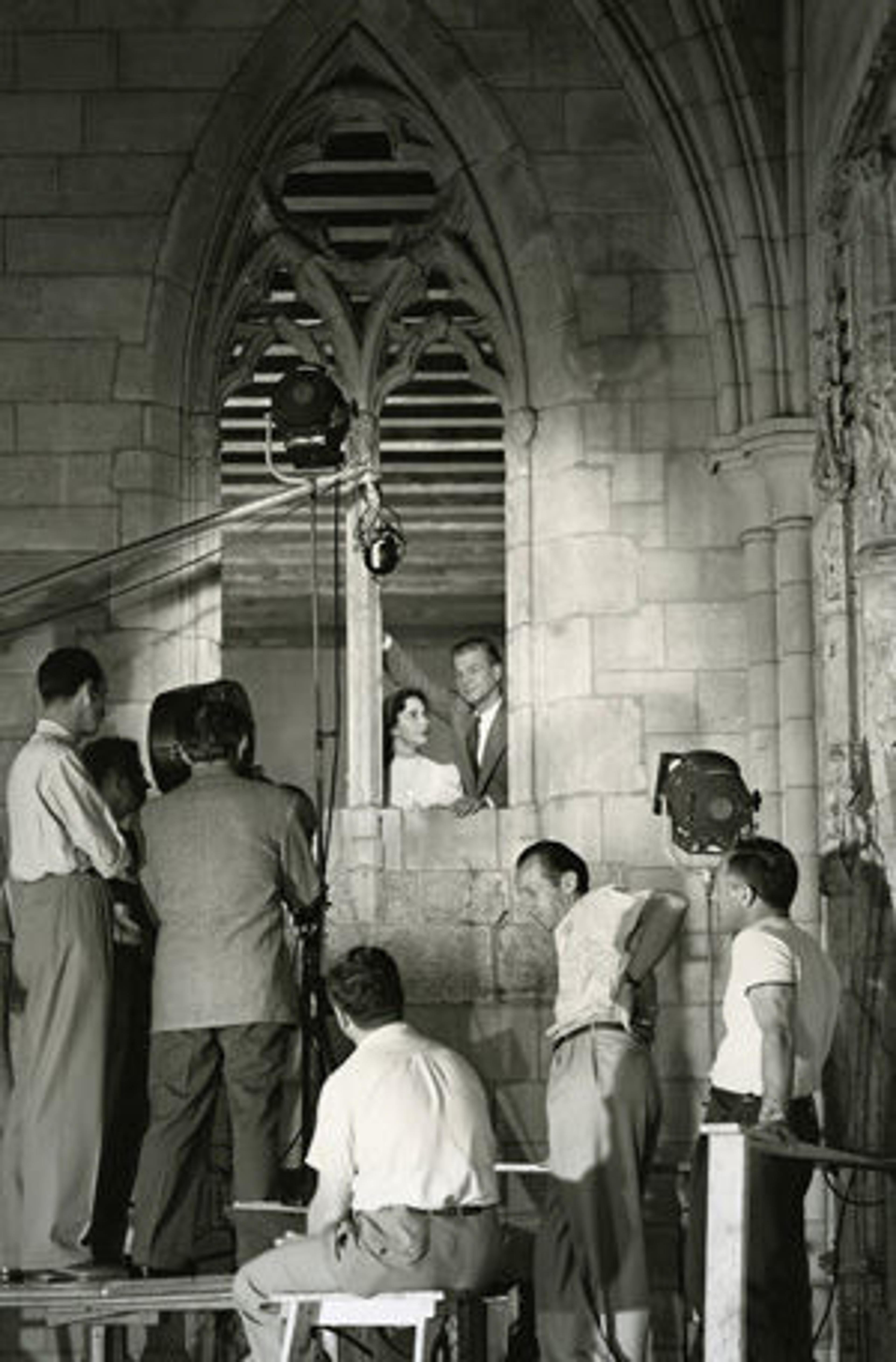 Joseph Cotten and Jennifer Jones peer through the double-lancet window from La Tricherie, France (34.20.1) during filming at The Cloisters for Portrait of Jennie.