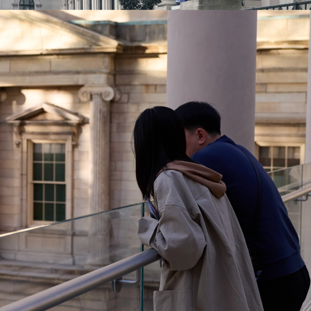 Two people look over The Charles Engelhard Court at The Met.