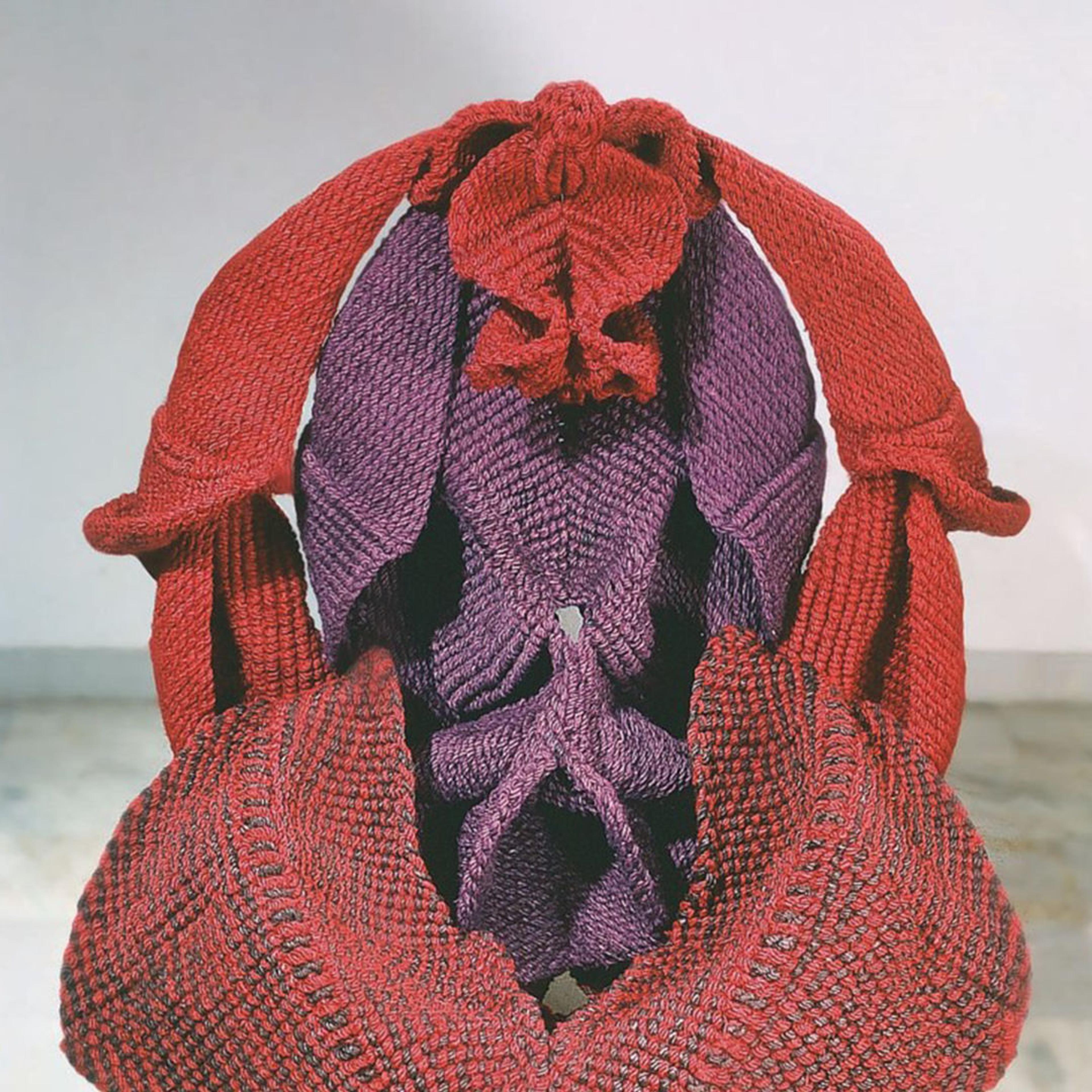 Composite image showing front and side views of Mrinalini Mukherjee’s freestanding fibre red and purple sculpture depicting unfurling forms that resemble female genitalia.