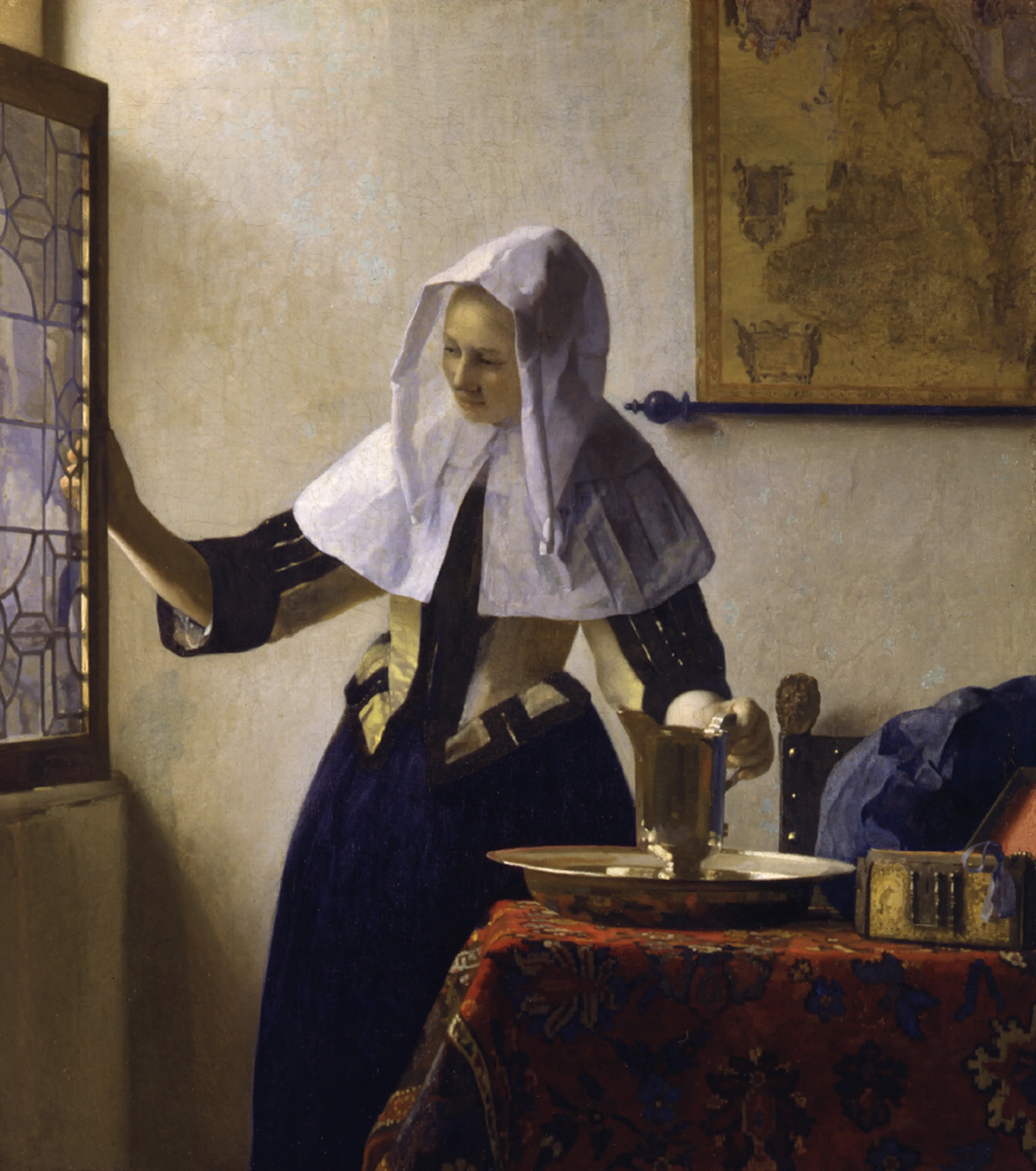 A woman in a white bonnet and dark dress stands by an open window, pouring water into a basin. A map hangs on the wall, and a table with a colorful cloth is nearby.