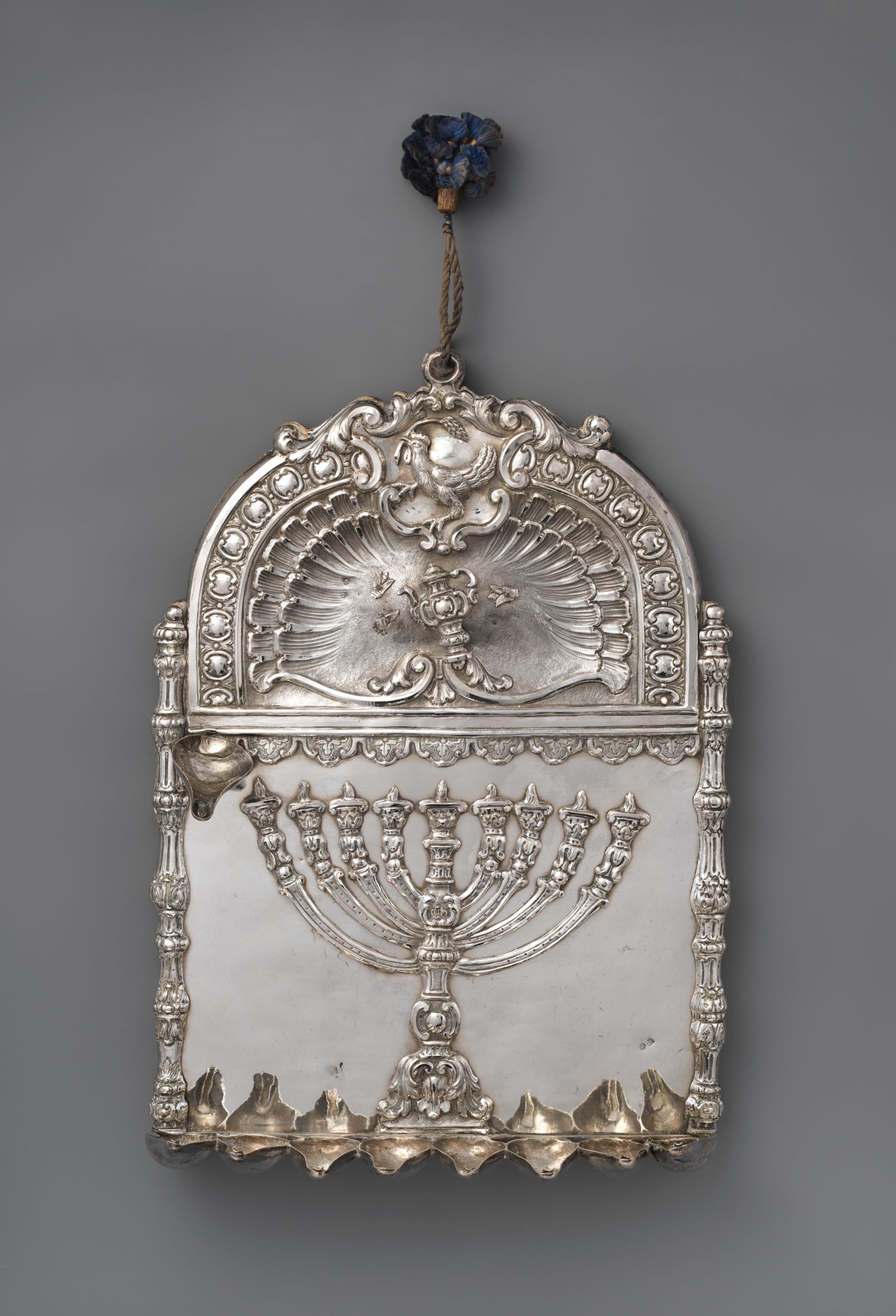 Vertical shot of matte silver Hanukkah lamp commissioned by the Baraffael family.