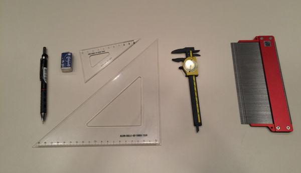 Tools of the trade (left to right): pencil, eraser, right triangles, caliper, profile gauge