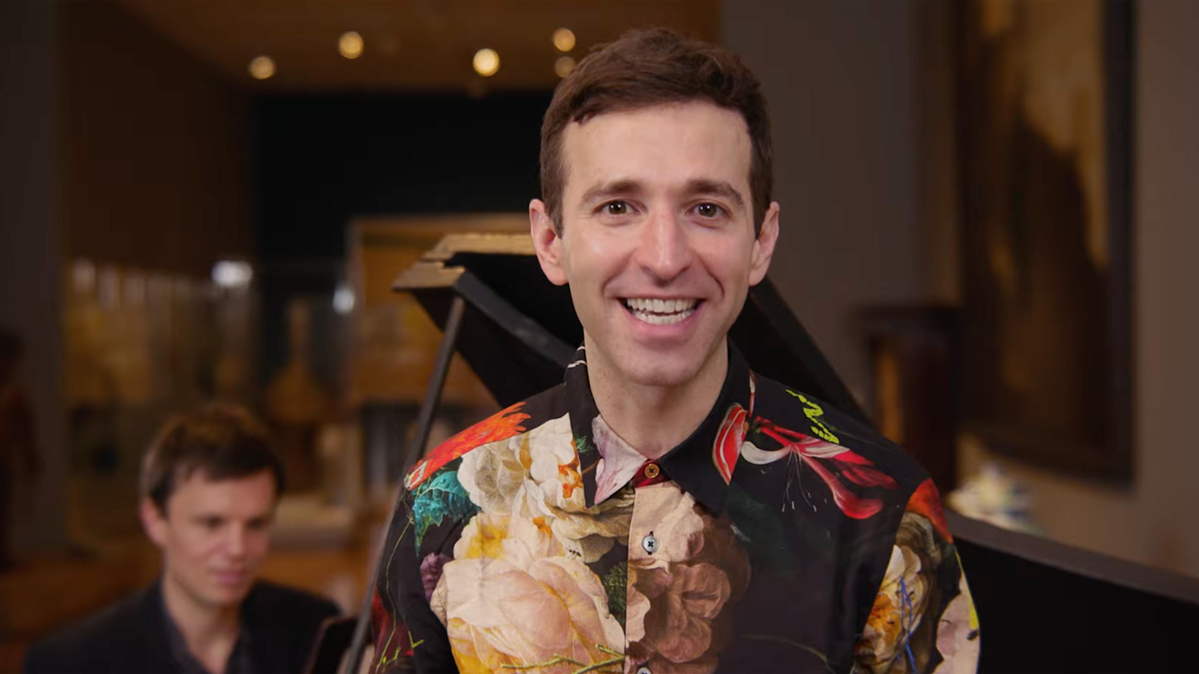 A smiling Anthony Roth Costanzo in a colorful floral shirt