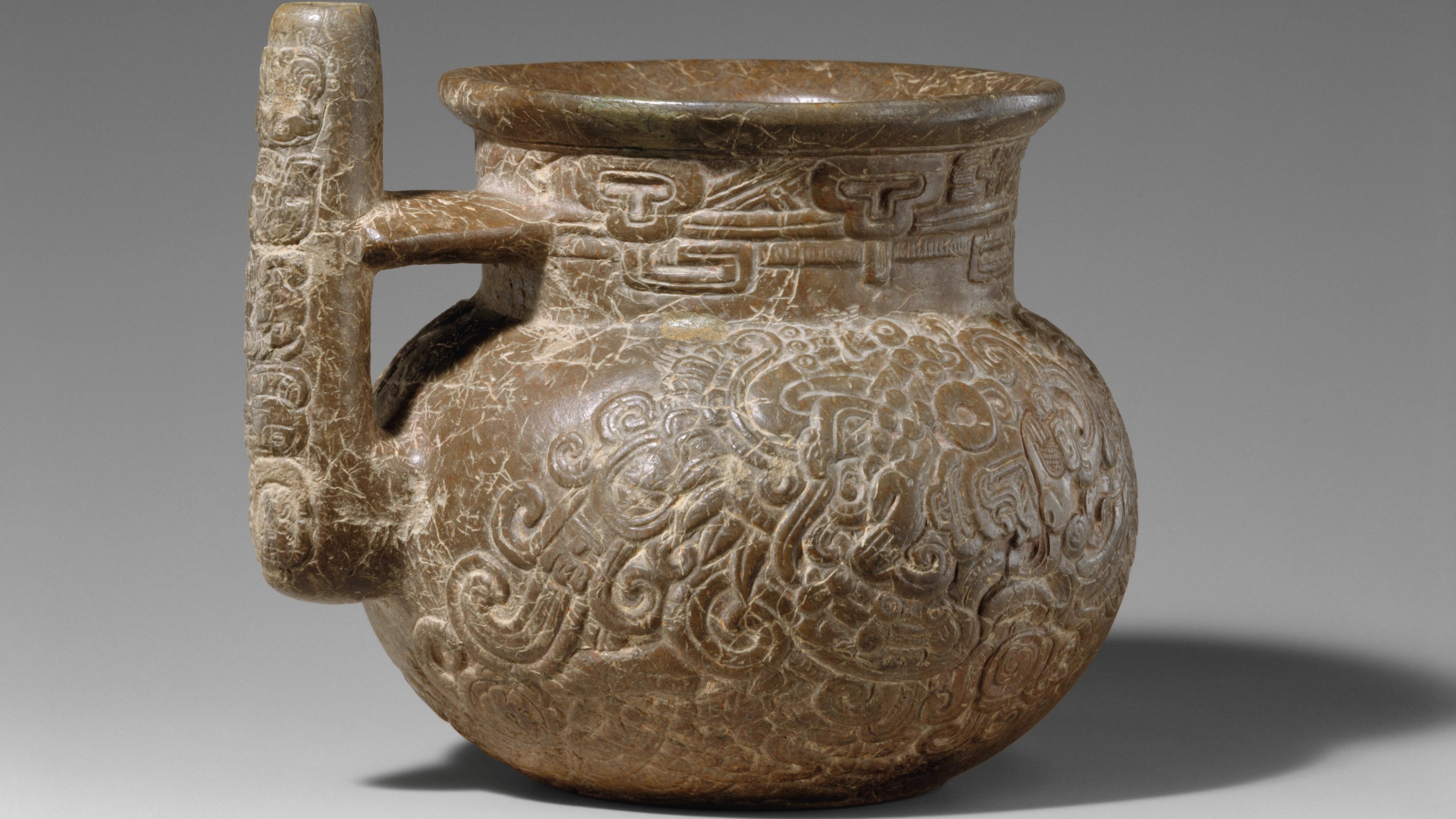 Sculpted stone spouted vessel