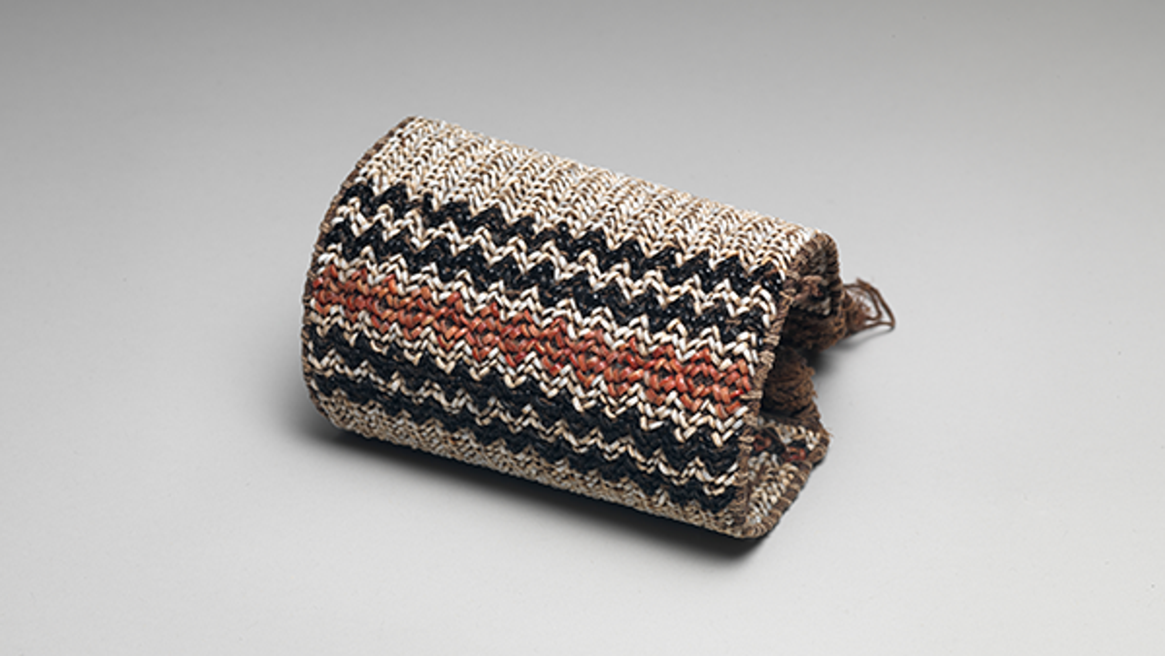 Arm or leg bands made from colored shell beads arranged in geometric designs