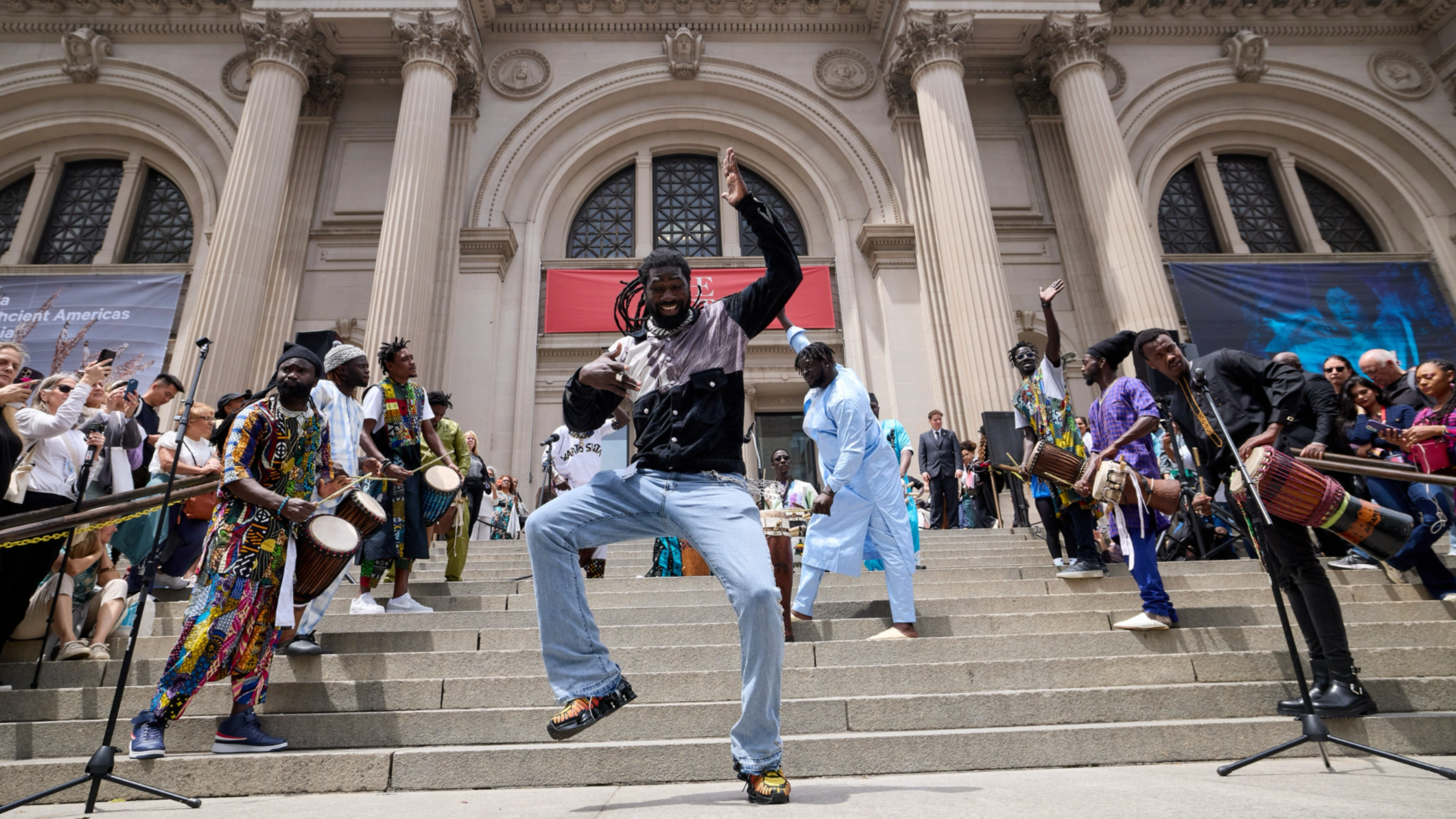 A man dancing on the steps of The Met.