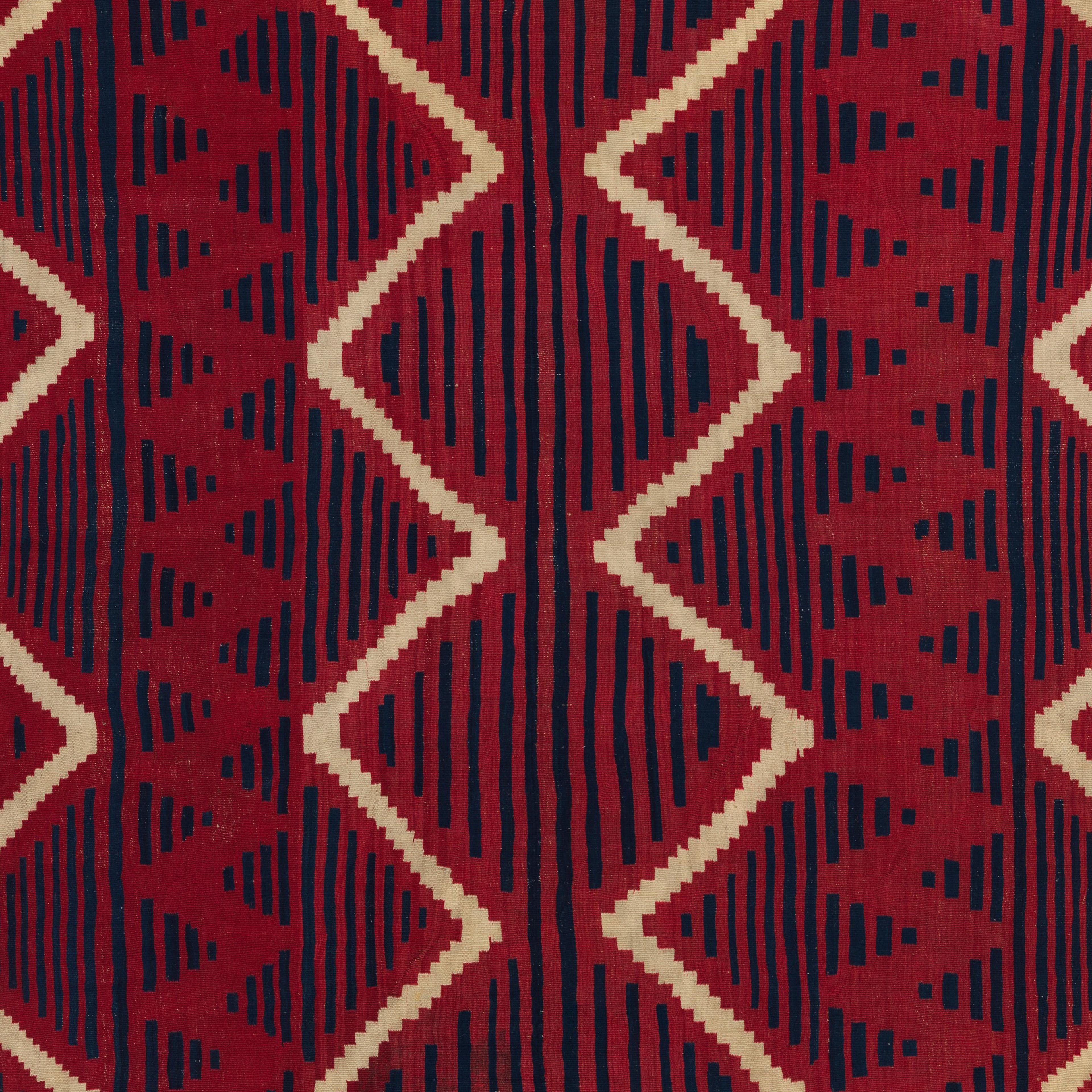 a 19th-century woven Serape of red, beige, and dark blue, featuring horizontal lines and diamond shapes—referred to by some as a rare "radio-wave" pattern.