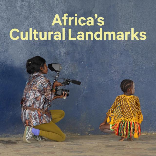 Woman holding a camera and filming a child in dancing attire, with text at the top reading "Africa's Cultural Landmarks"