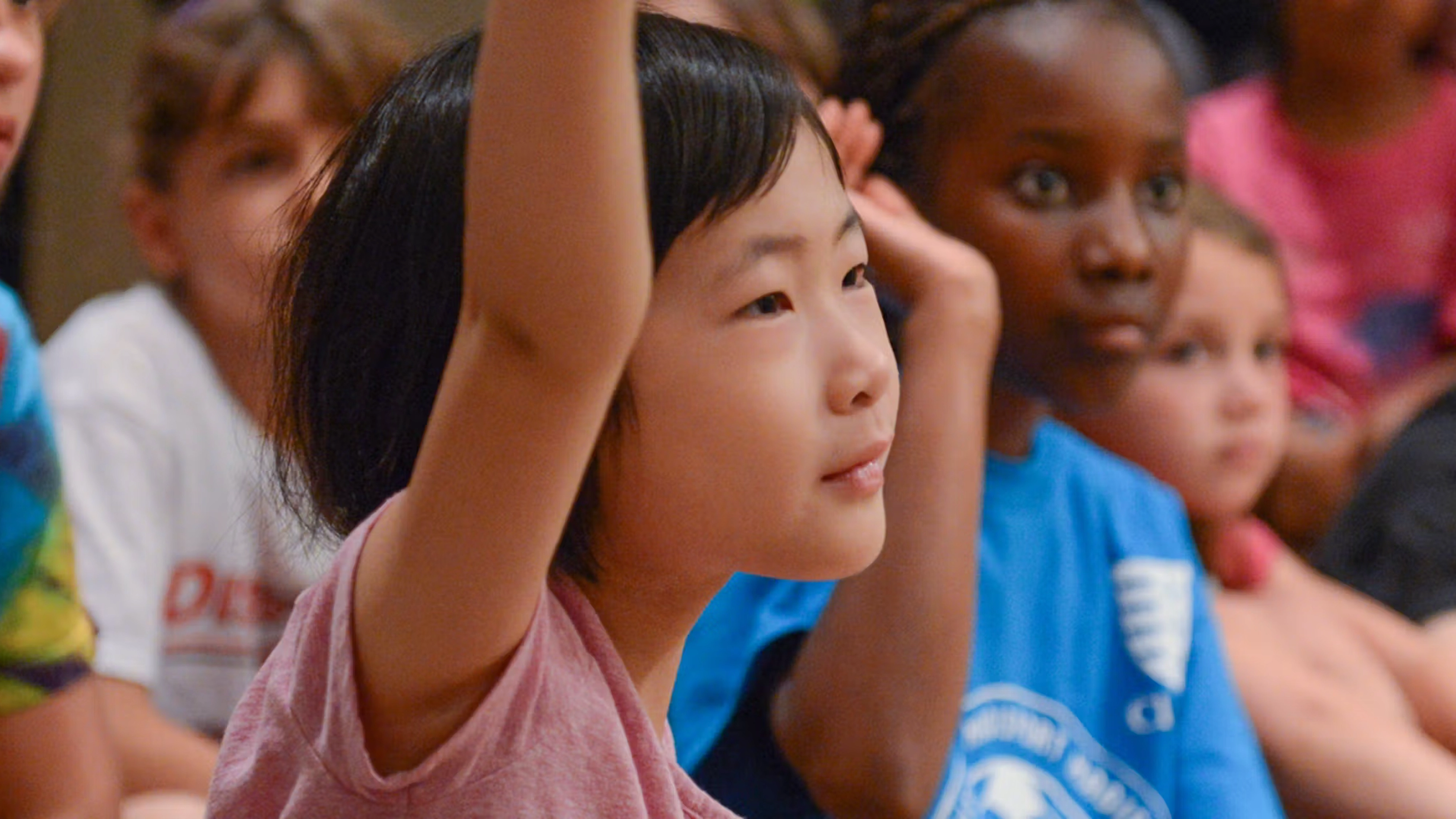 A student raising their hand. 