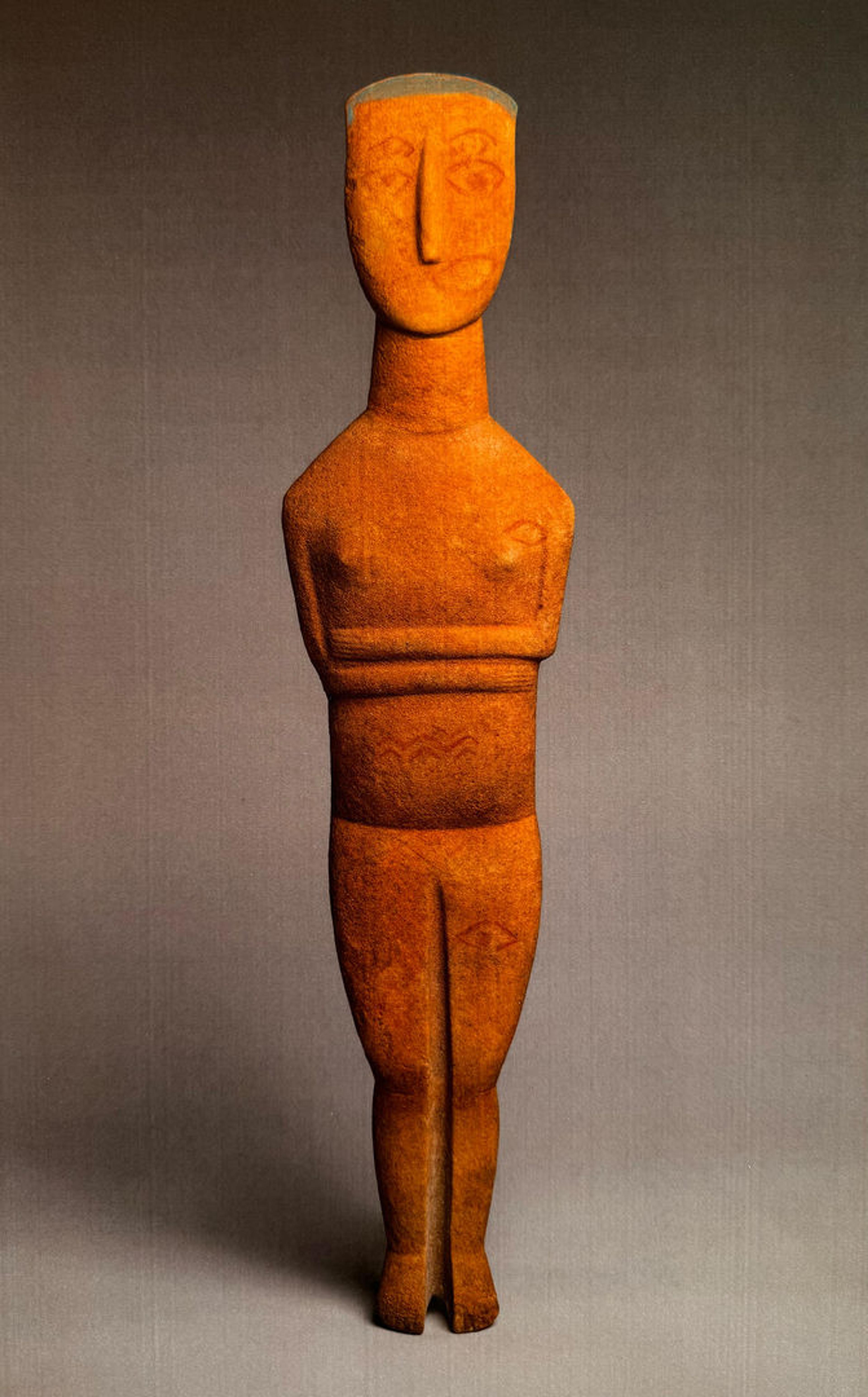 Marble statue of woman, with her arms behind her back.