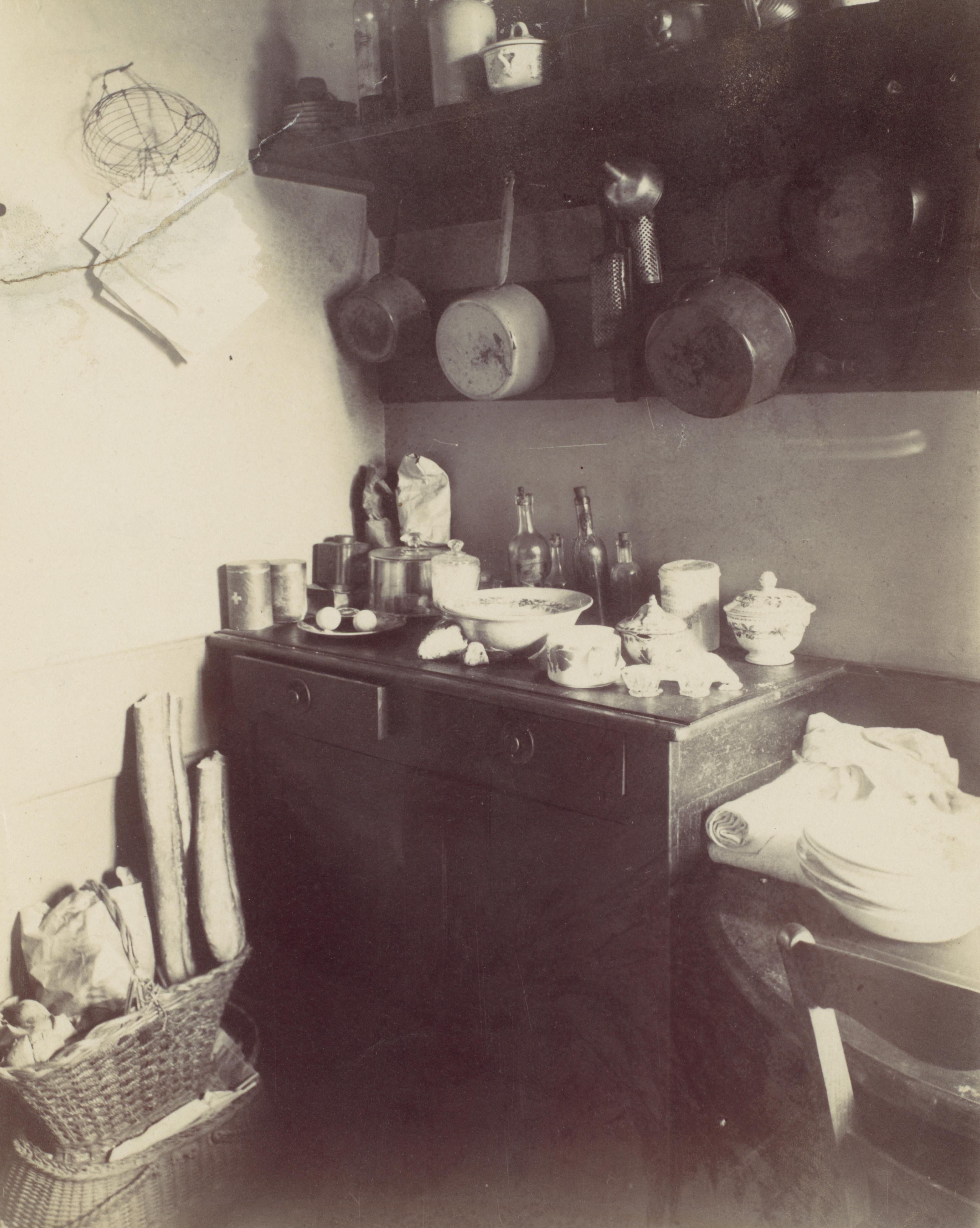 Black and white photograph of a kitchen from 1910.