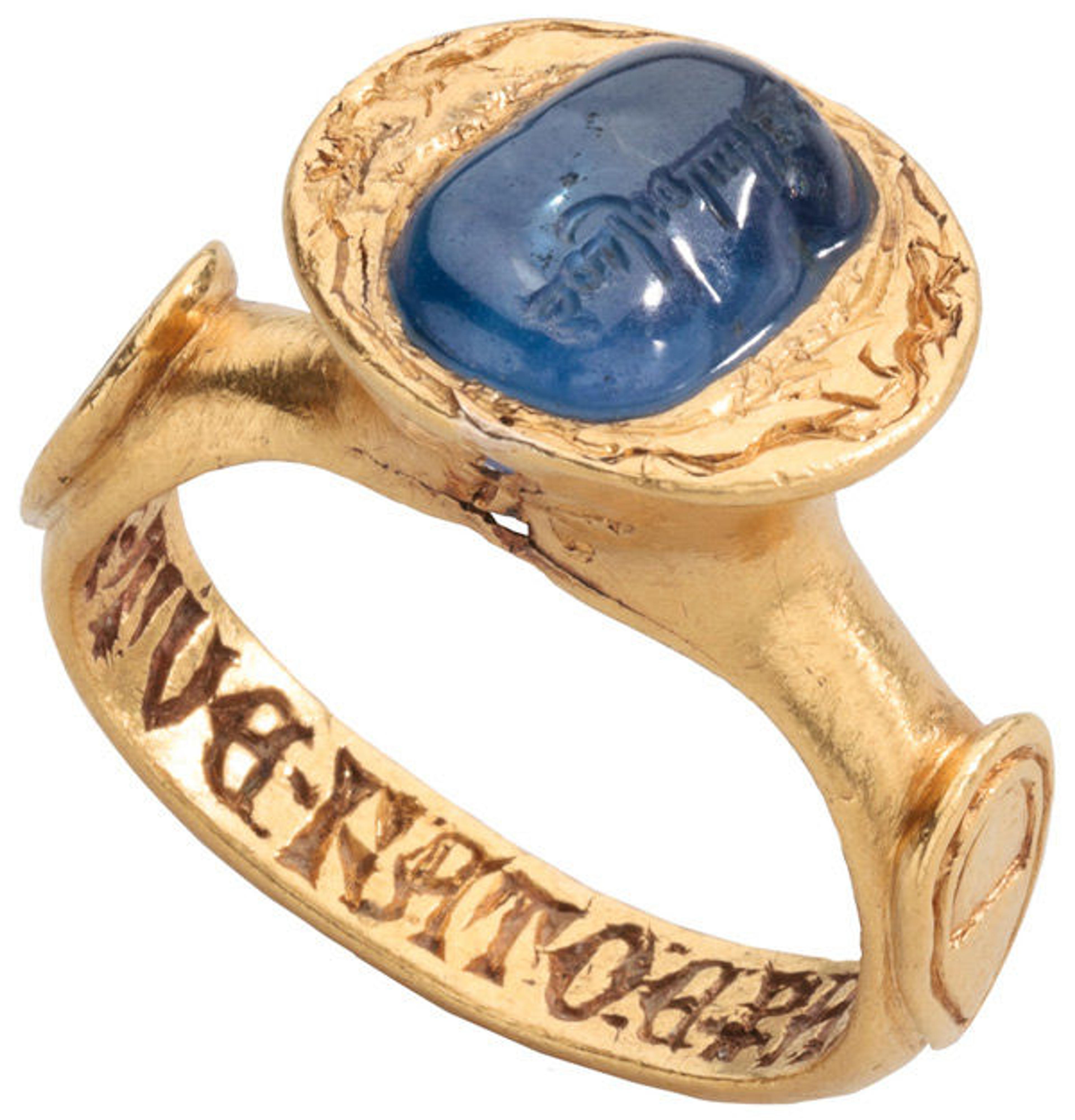 Inscribed Sapphire Ring, late 14th century (setting); 10th century? (sapphire). Italian. Gold, sapphire; Height 30.8 mm; hoop outer diam. 27.89 mm; bezel 16.15 x 17.4 mm; weight 23.5 grams; US size 7.25; UK size O. Griffin Collection