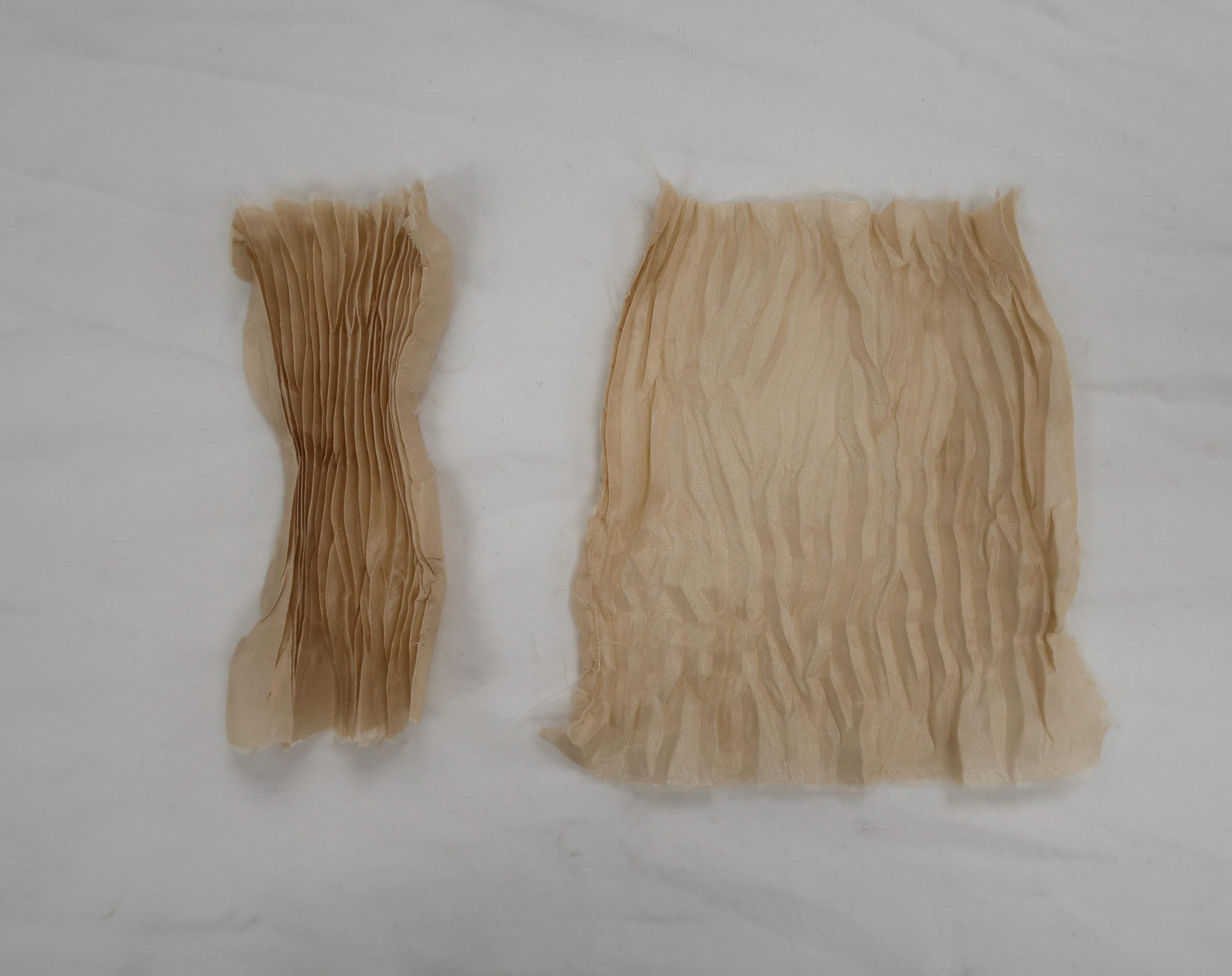 Beige fabric gathered tightly into narrow pleats, and another piece of fabric where the pleats have relaxed into softer wrinkles.