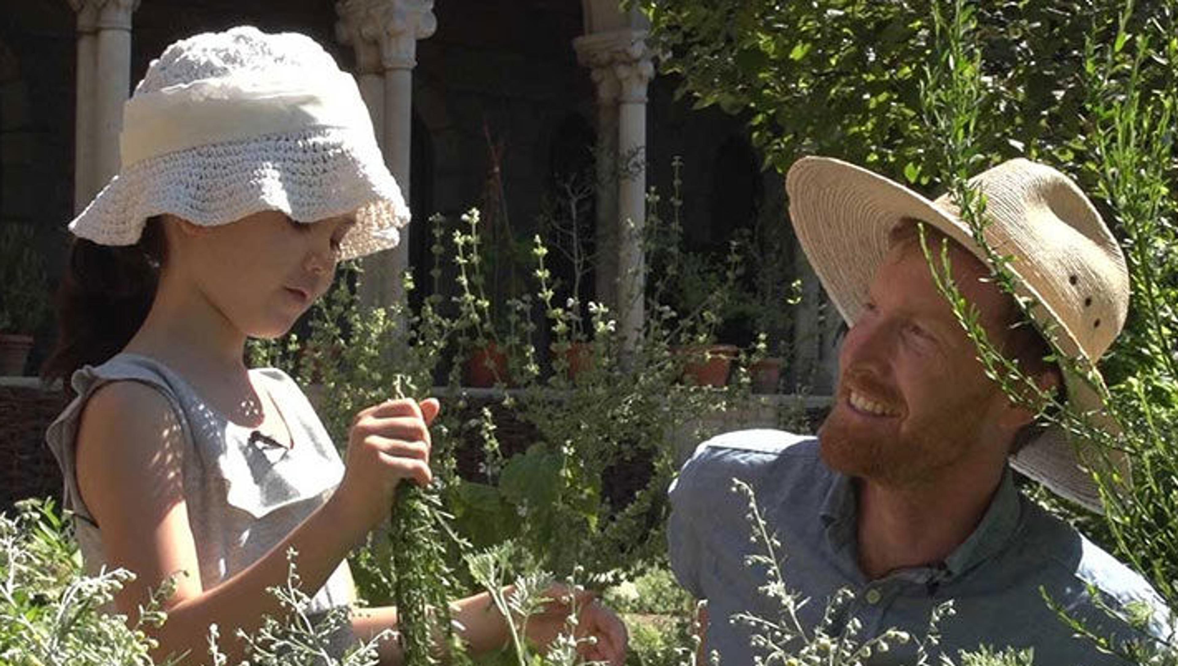 A Met horticulturalist and a child in a garden at The Met Cloisters
