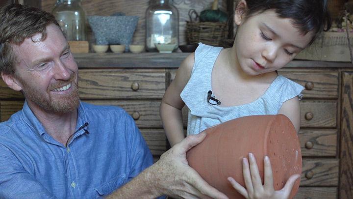 Ella and Caleb with a watering jug