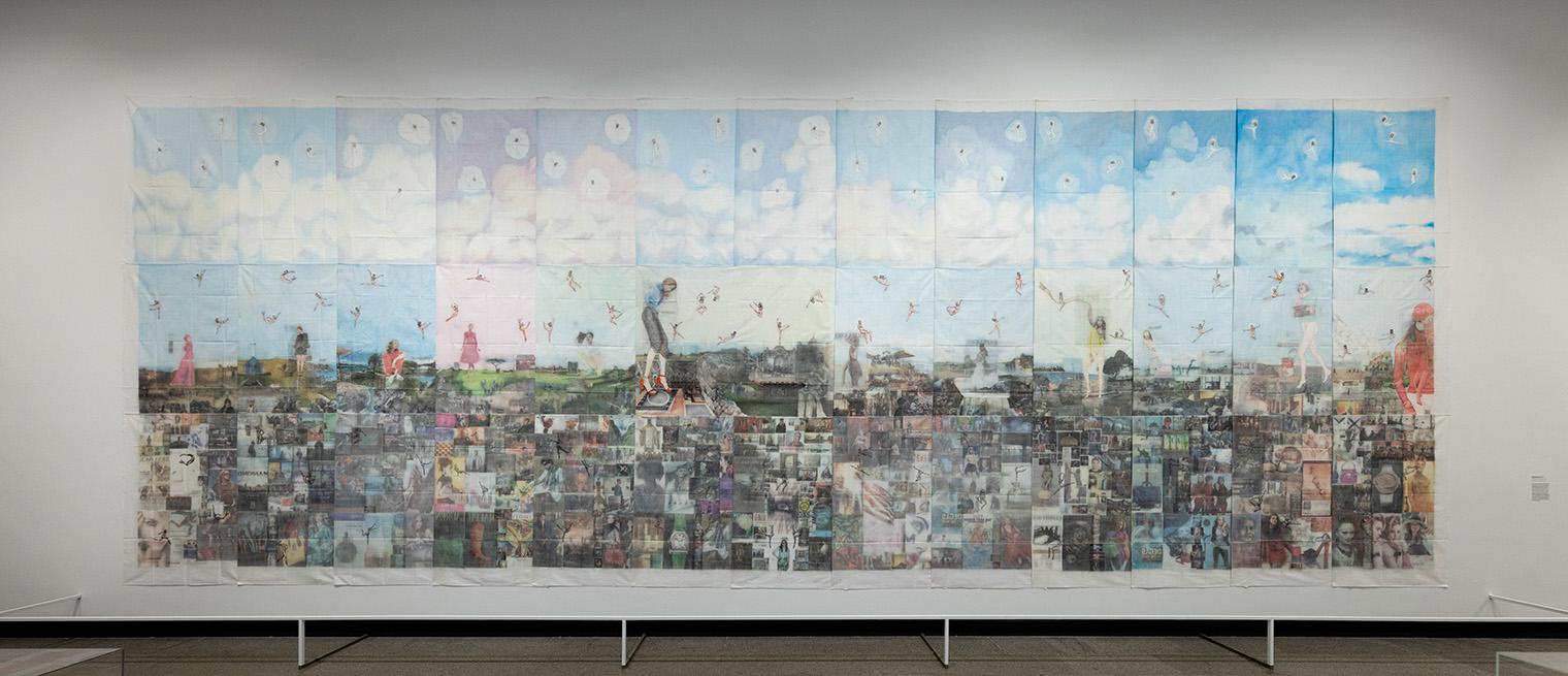 Collage of vivid images with a serene sky backdrop fills the wall. Figures and objects float against blue skies, blending realism and whimsy.