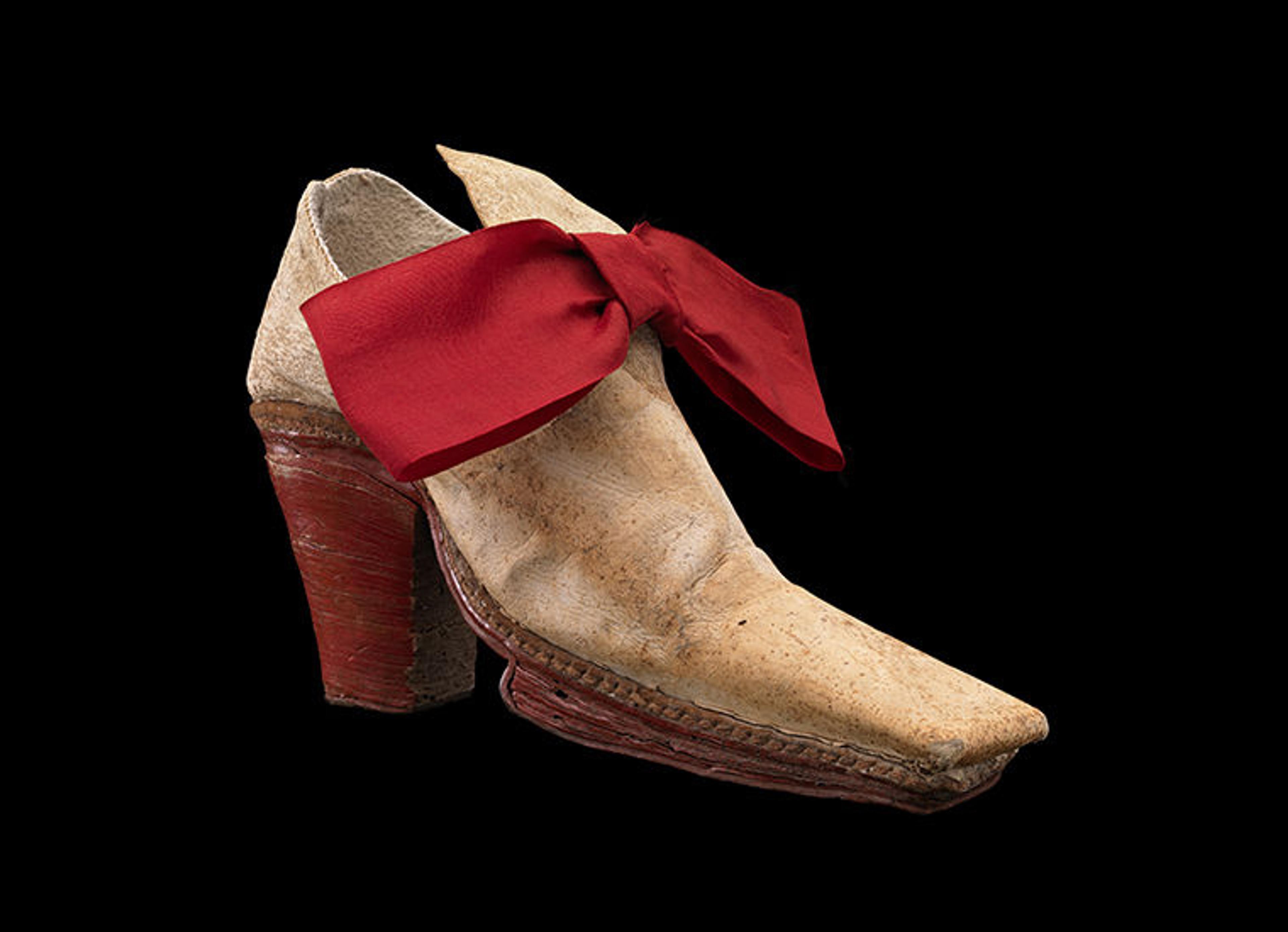 The Monsieur Shoe with red heel and red bow.
