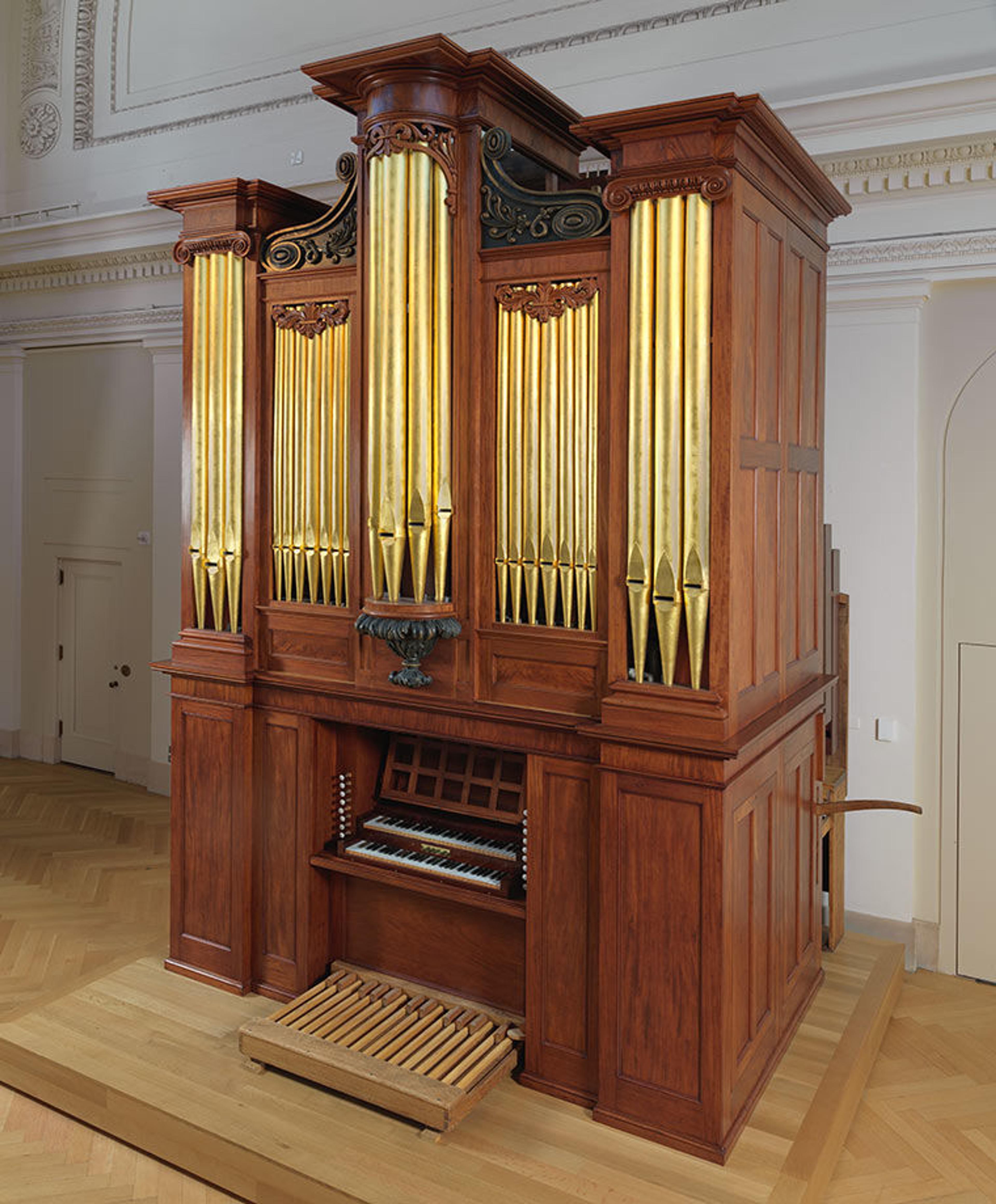 The Thomas Appleton organ on the balcony in raking light.