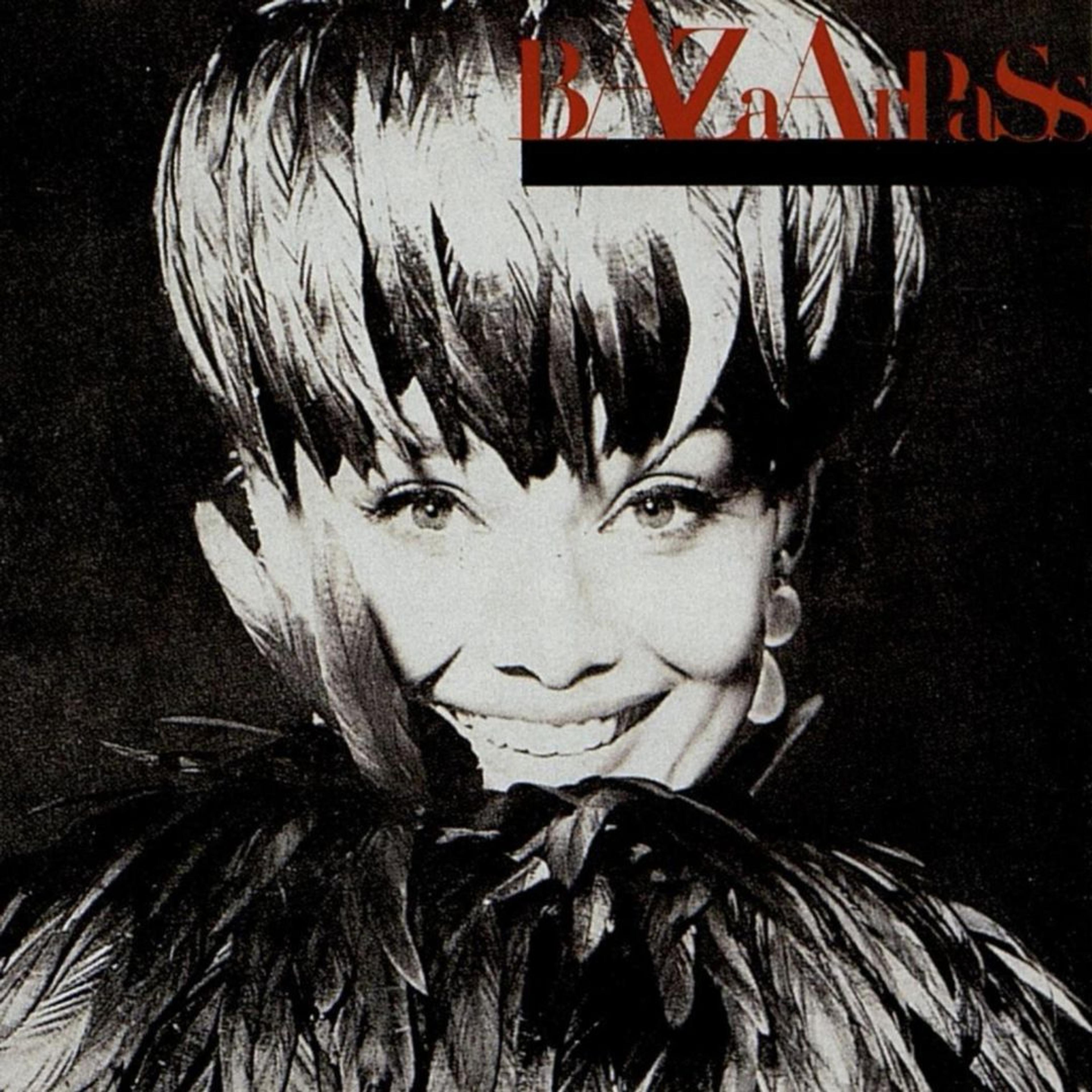 Black-and-white headshot of Audrey Hepburn in a feathered hat and ruff