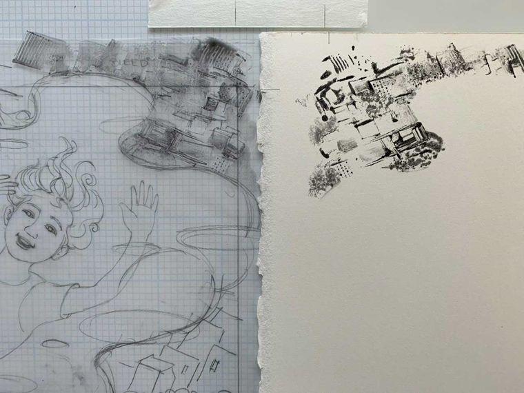 On the left, a pencil sketch of a girl floating through the sky above a cloud with a cityscape pattern on the upper right corner. To the right is a white sheet of paper with the ink of the cityscape pattern transferred onto its upper left corner.