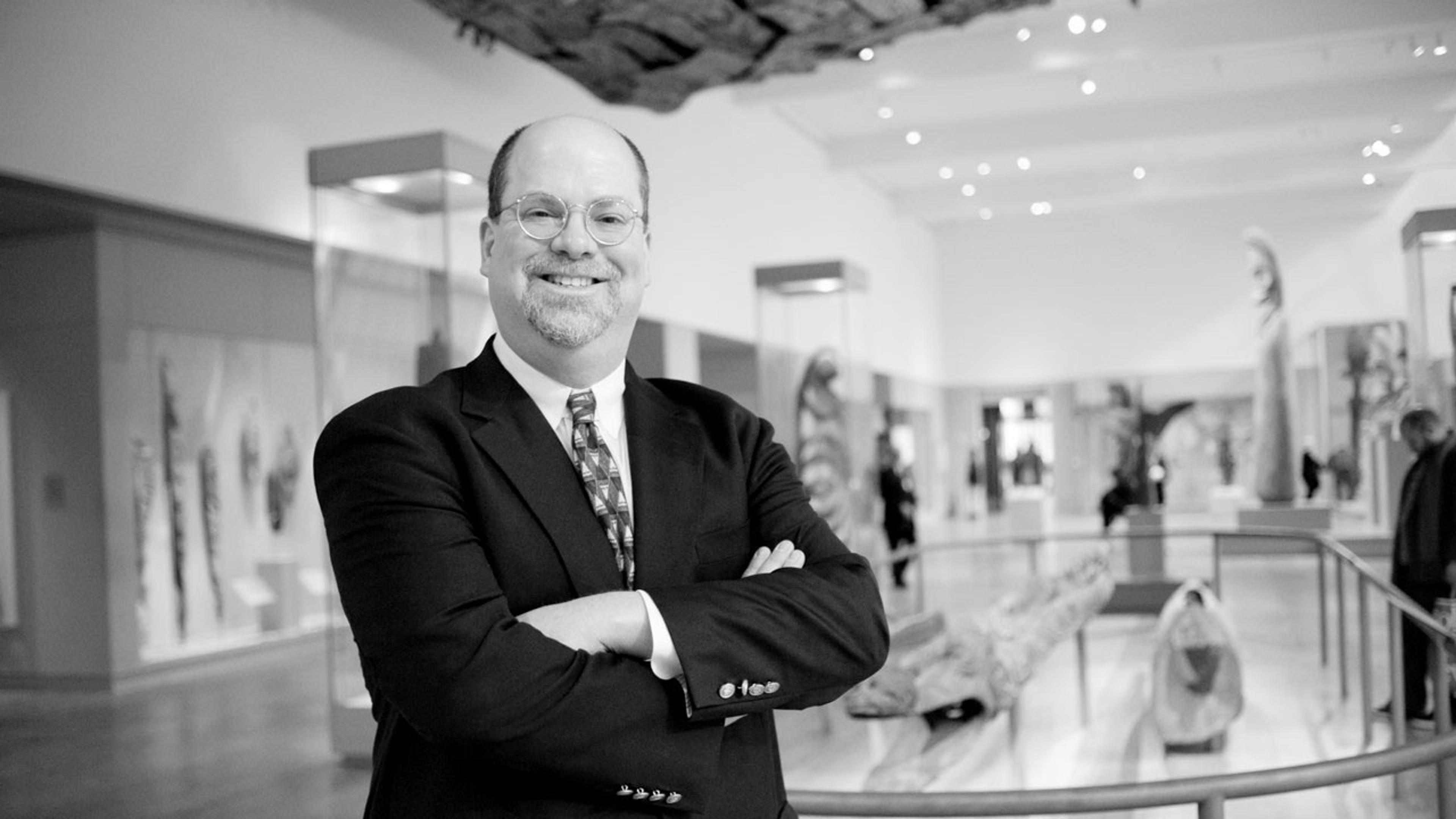 Black and white photograph of curator Eric Kjellgren in The Met galleries