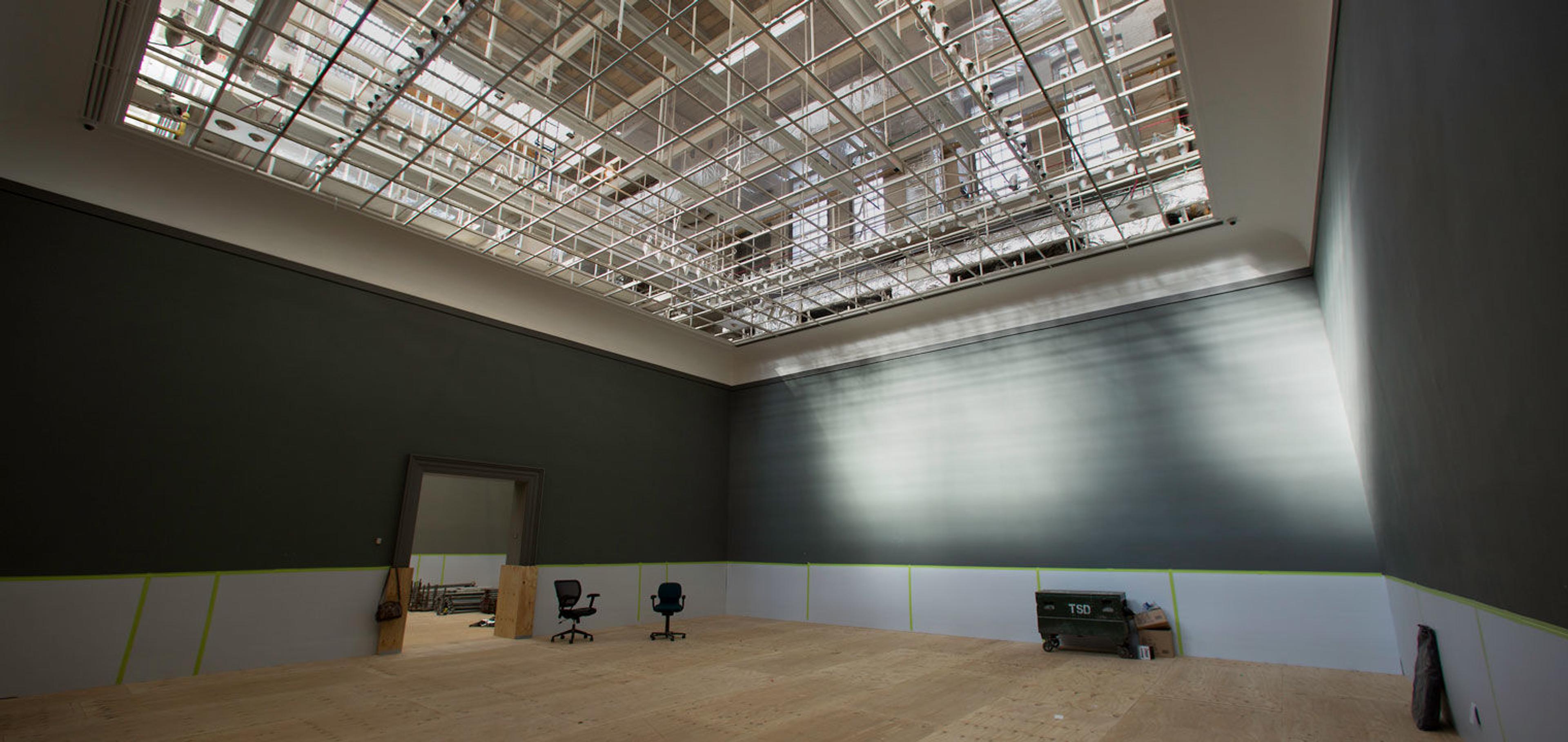 View of an empty gallery in The Met with exposed skylights in the ceiling