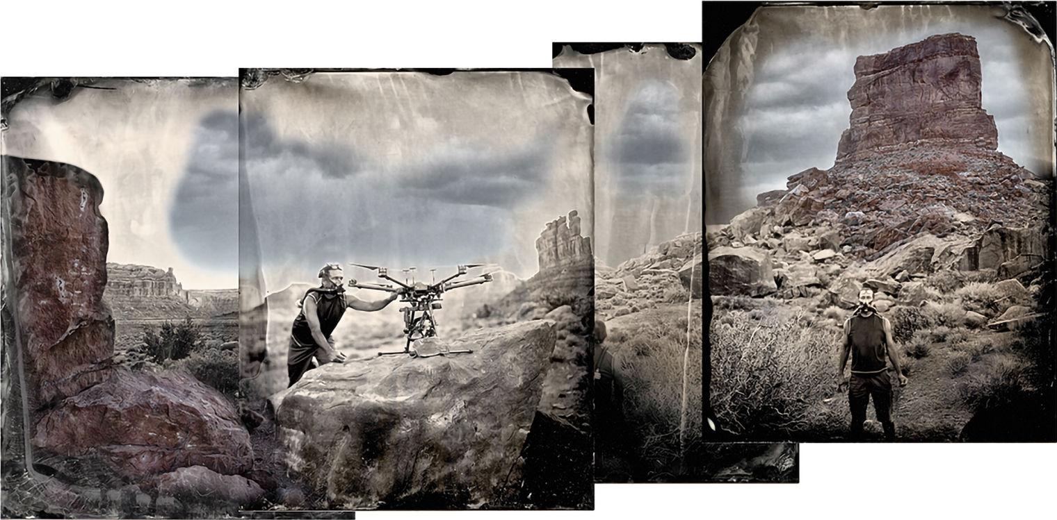 Man holding a drone in a landscape while wearing a respirator mask