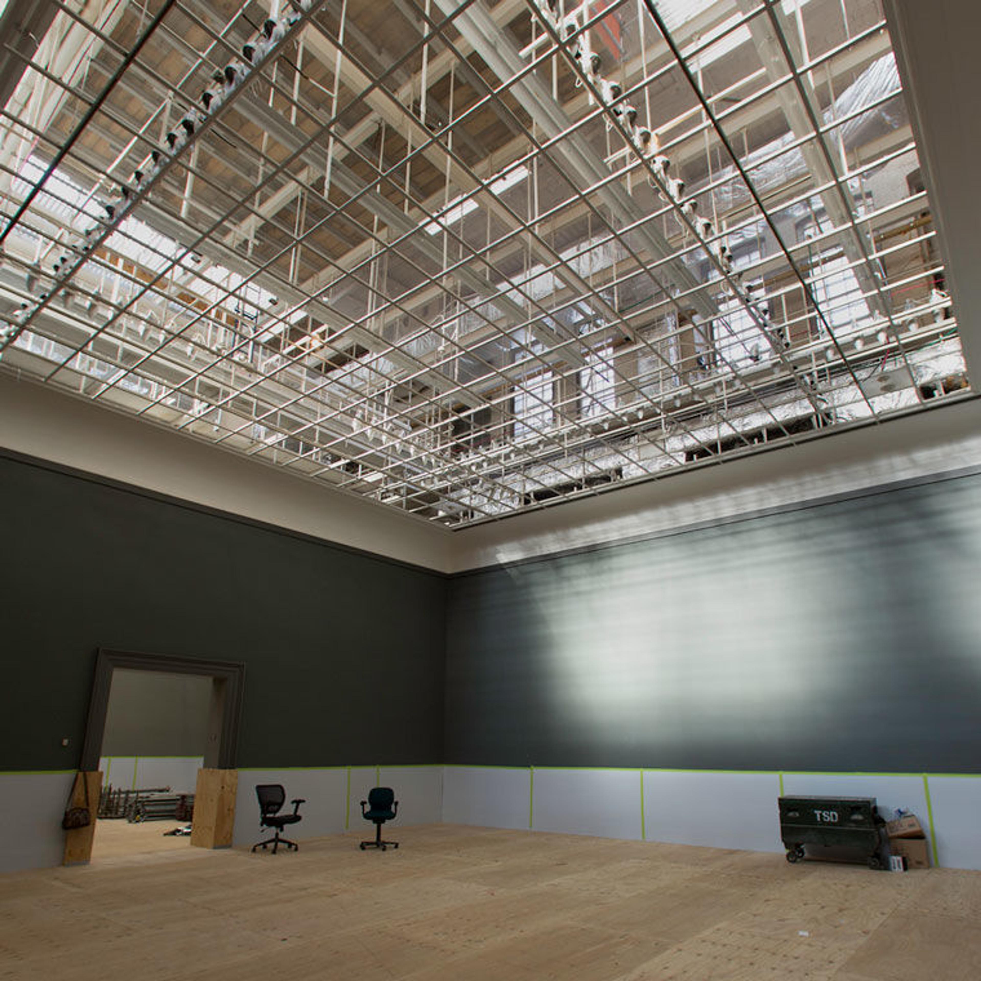 View of an empty gallery in The Met with exposed skylights in the ceiling