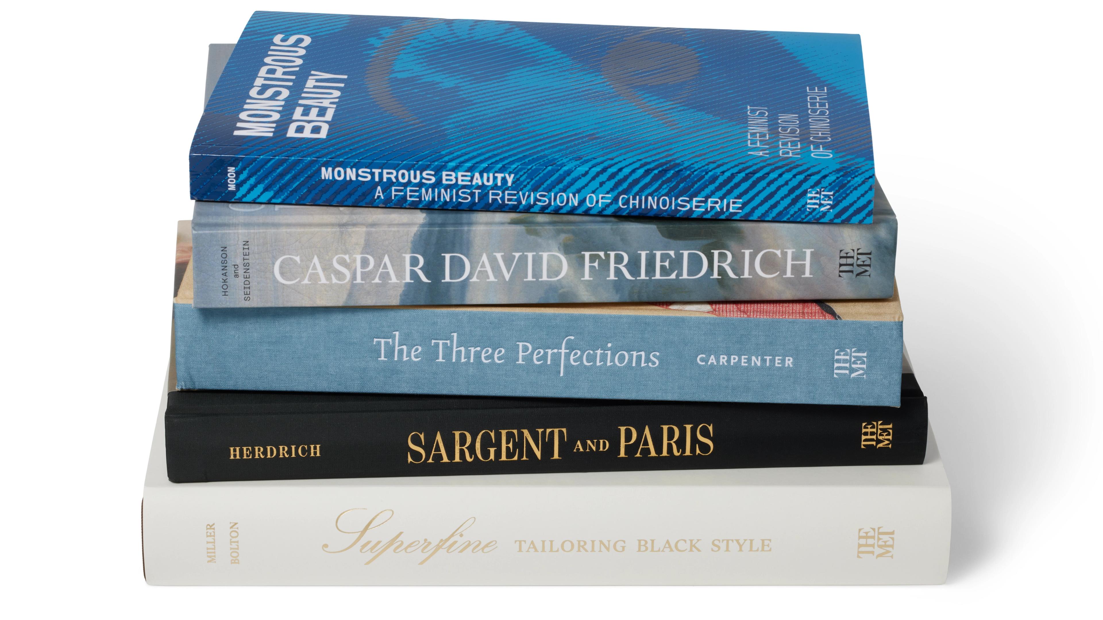 A stack of five books published by The Met