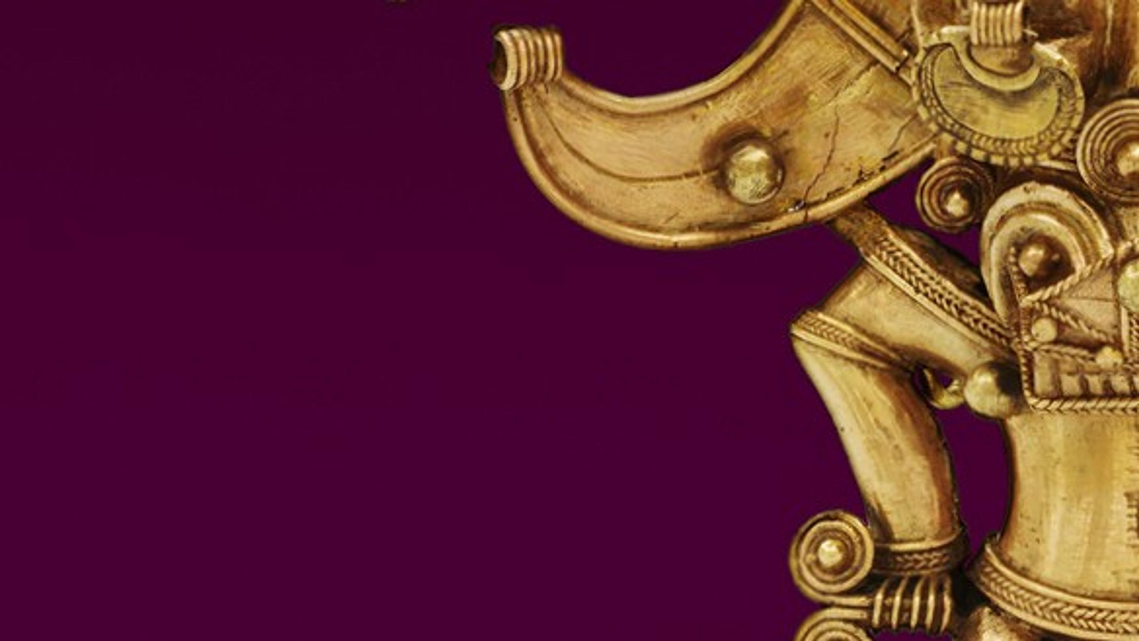 A cropped view of a figure in metal with decorative filigree