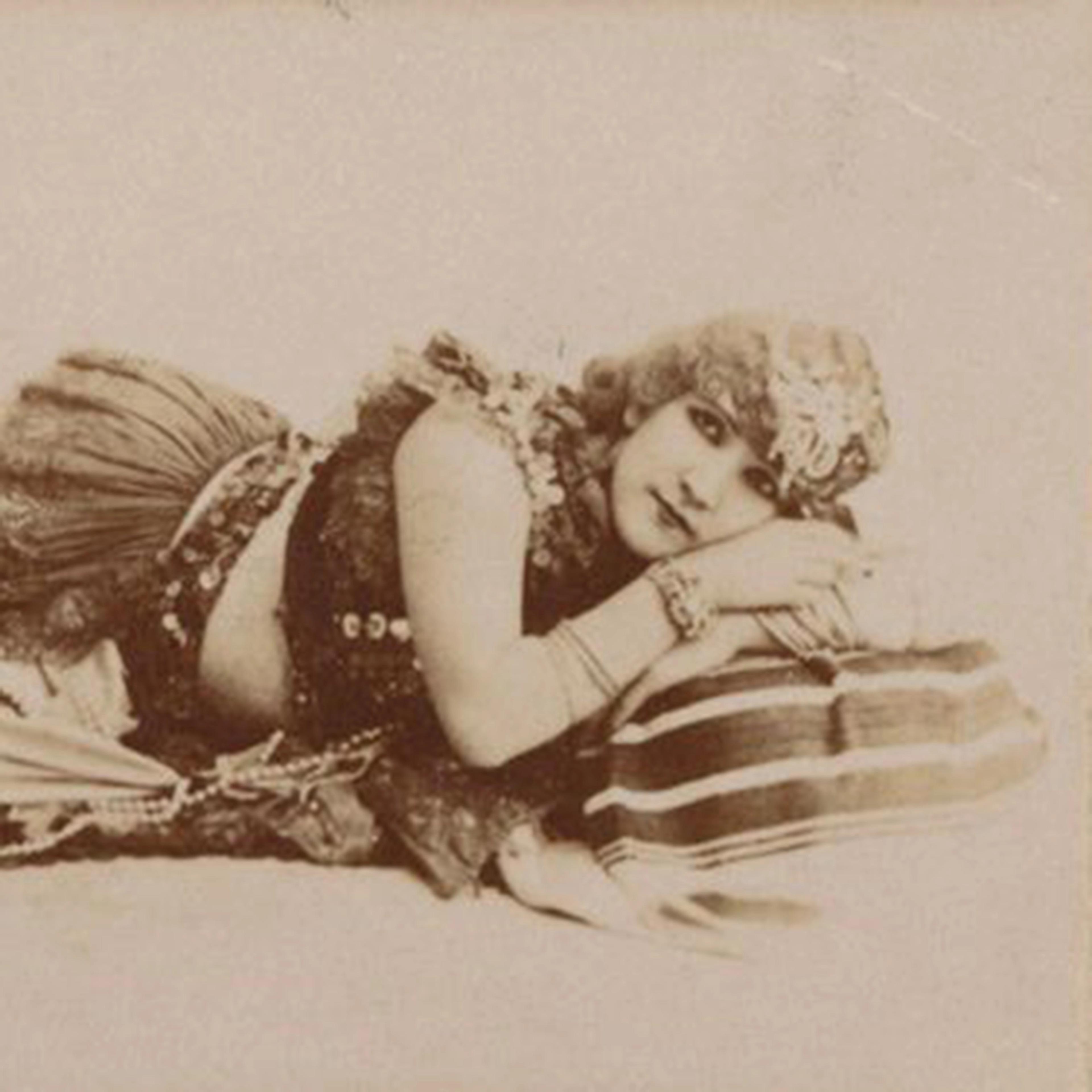 Portrait of Omene lying horizontally, arms folded under her head