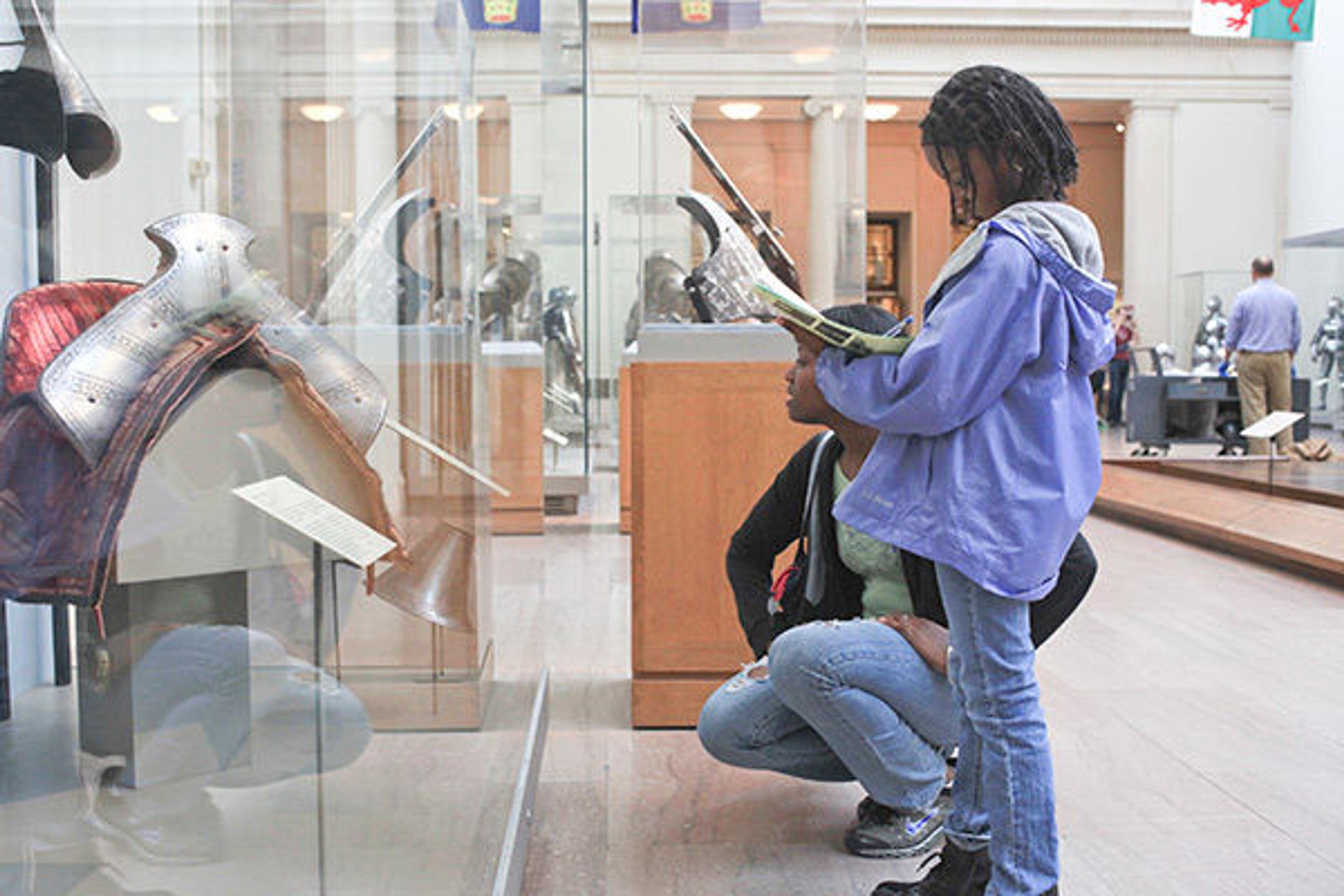 A girl sketching in the Arms and Armor galleries