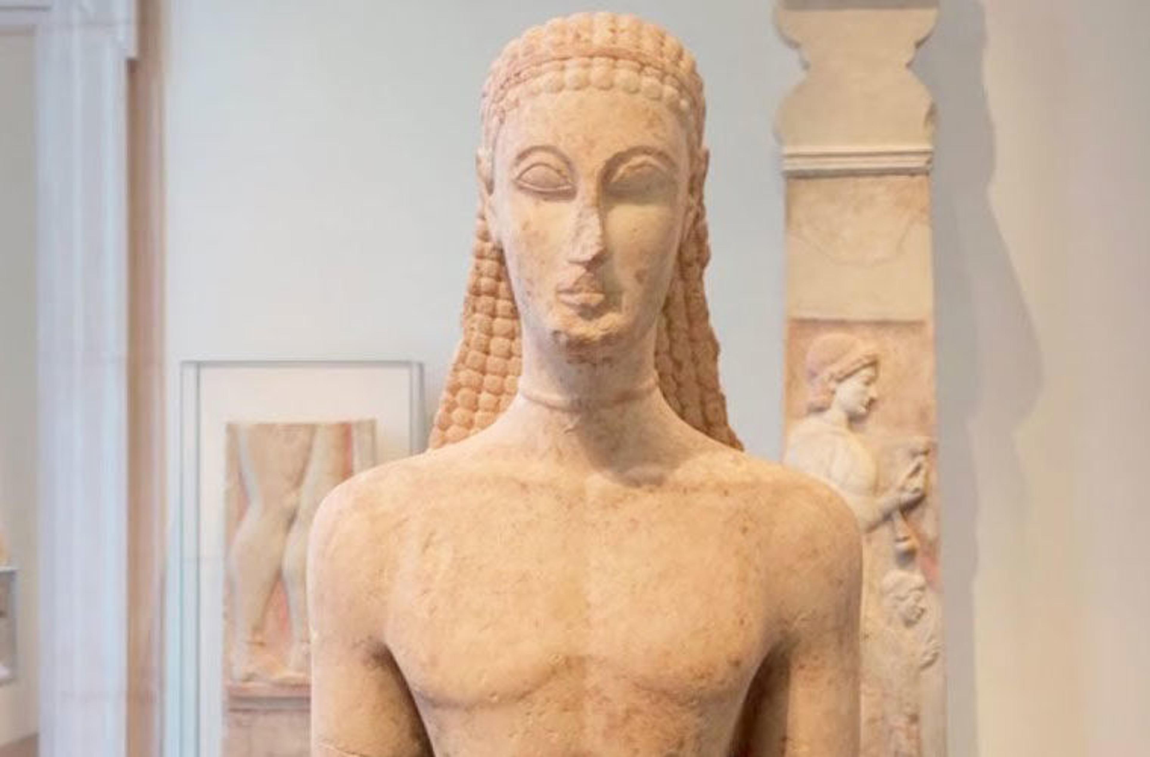 Early Greek sculpture of a standing youth.