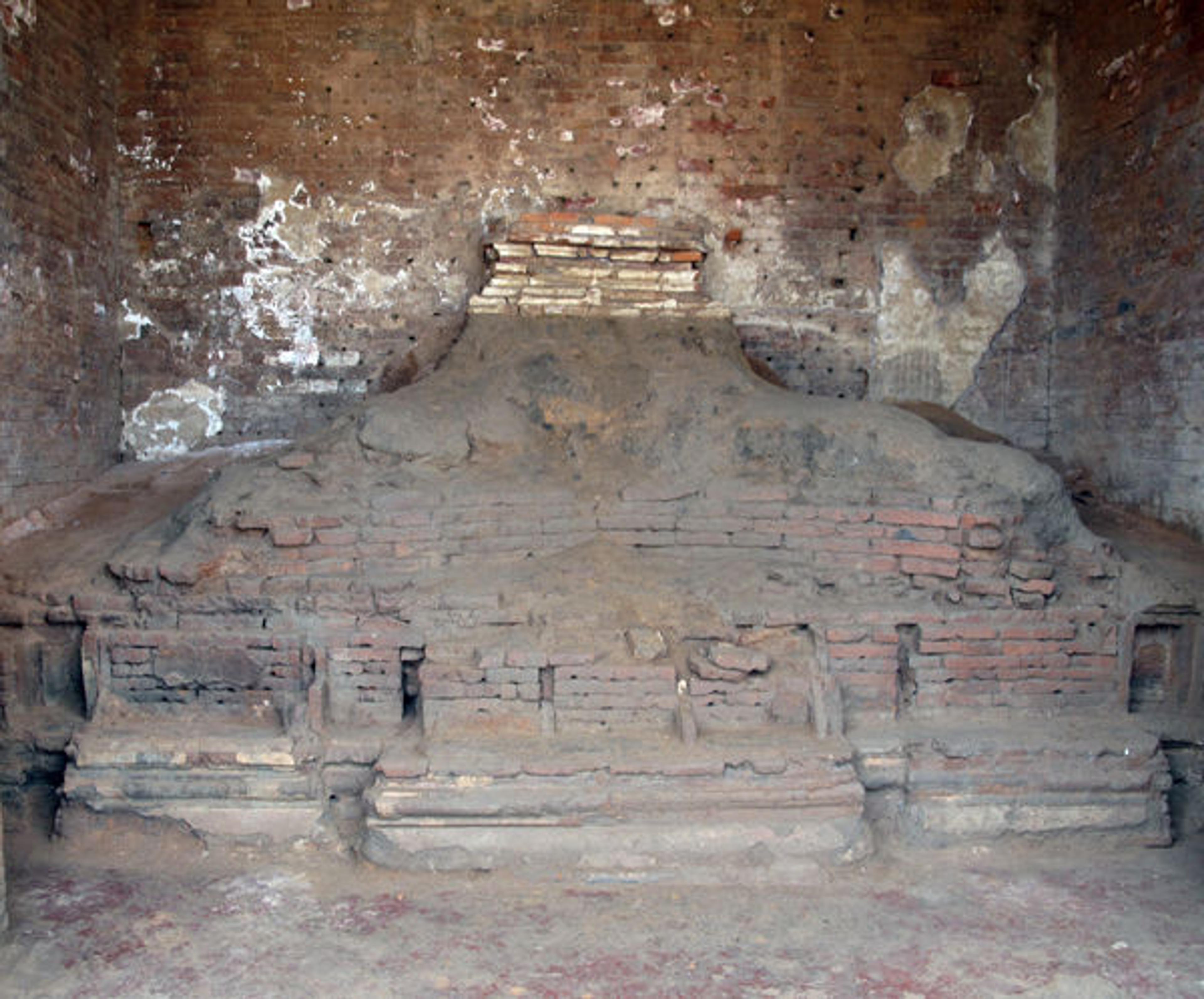 Remnants of the throne base and legs of a monumental Buddha in one of the four directional shrine of the image temple at the center of the Vikramashila monastery
