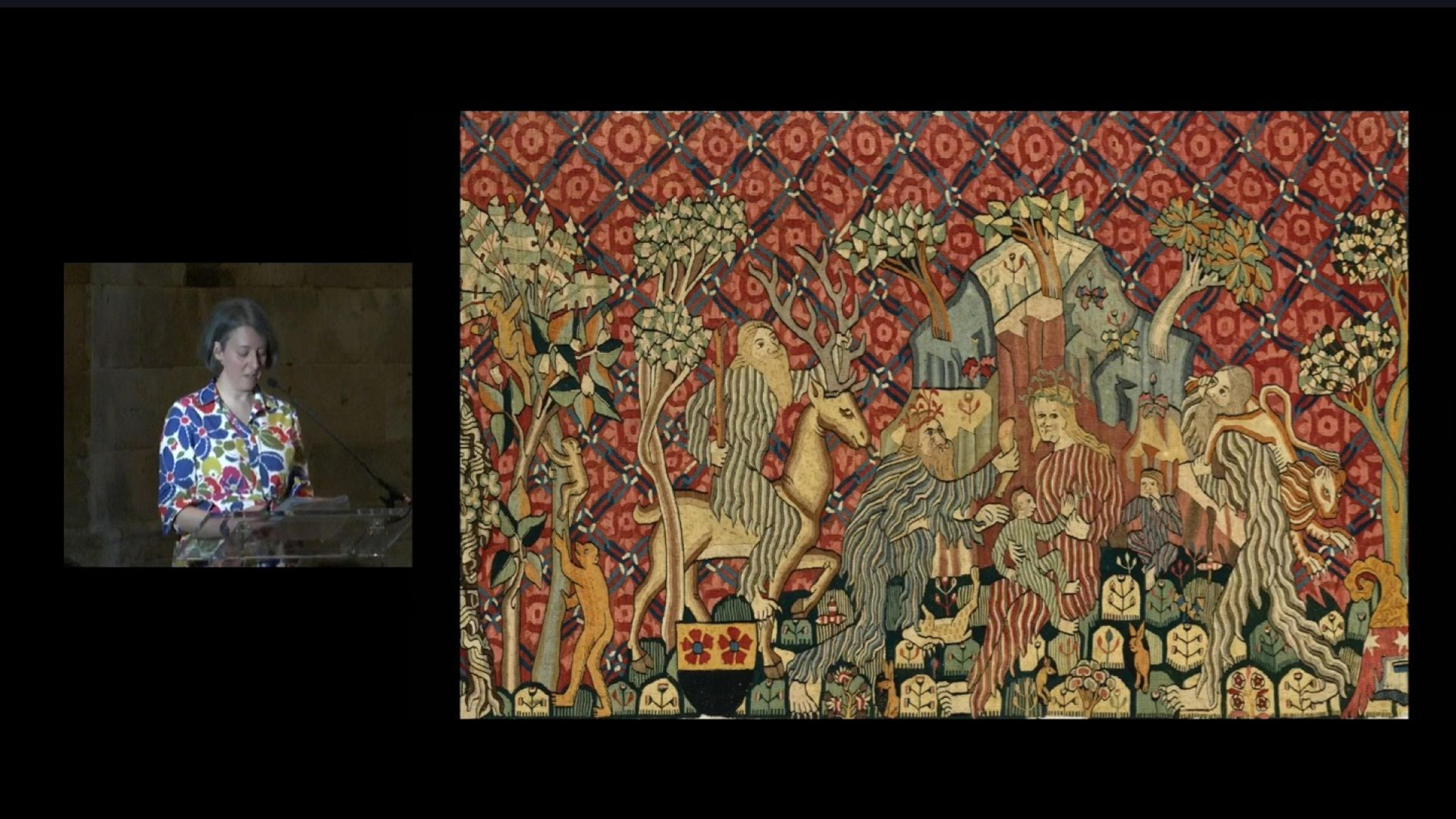Inset of a woman speaking at a podium, next to an image of a richly colored tapestry showing bearded men and wild animals.