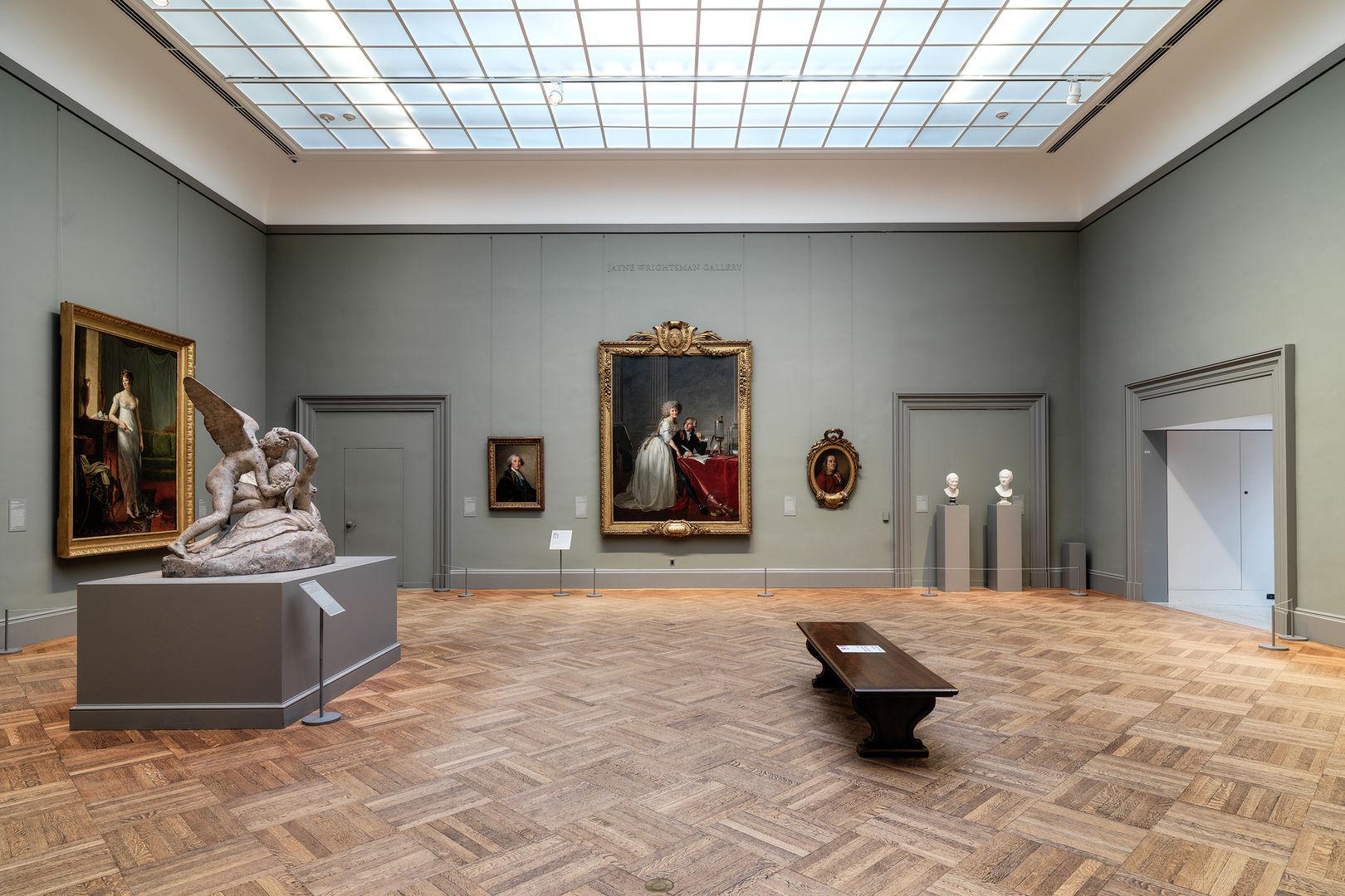 Wide shot of an empty gallery in European paintings with four paintings and three sculptures.