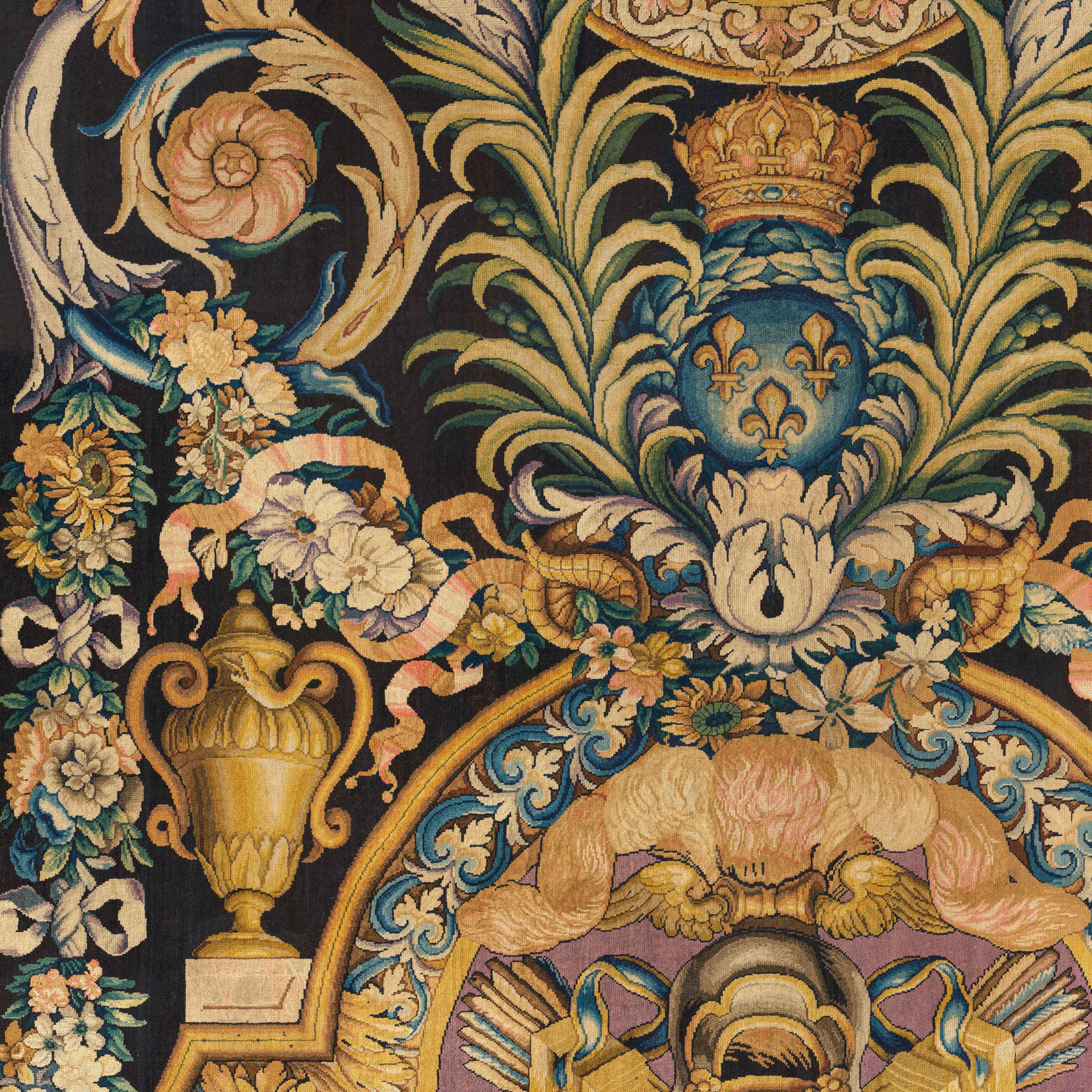 Intricate tapestry with floral motifs, a golden urn, and a crowned blue emblem with fleur-de-lis.
