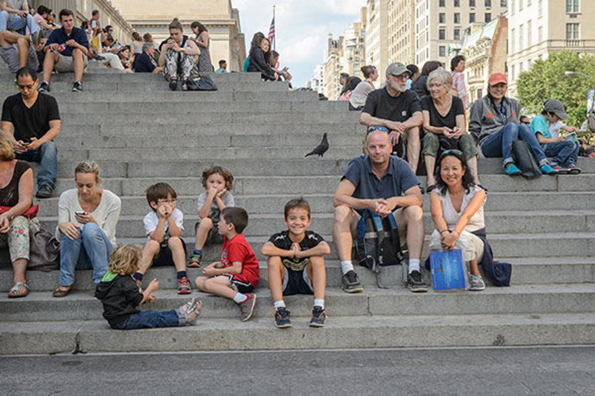 A family sat on the front steps of The Met Fifth Avenue