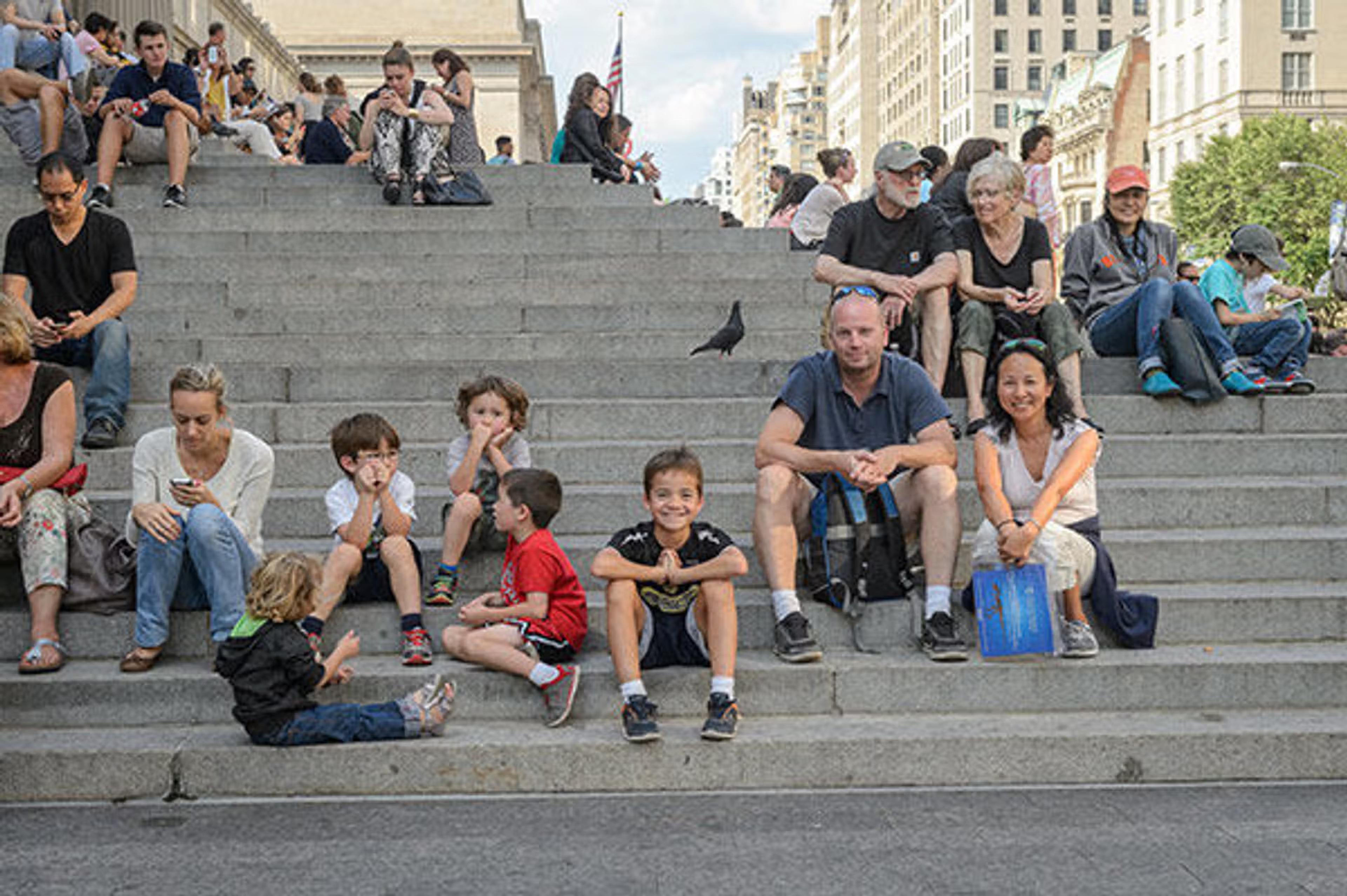 A family sat on the front steps of The Met Fifth Avenue